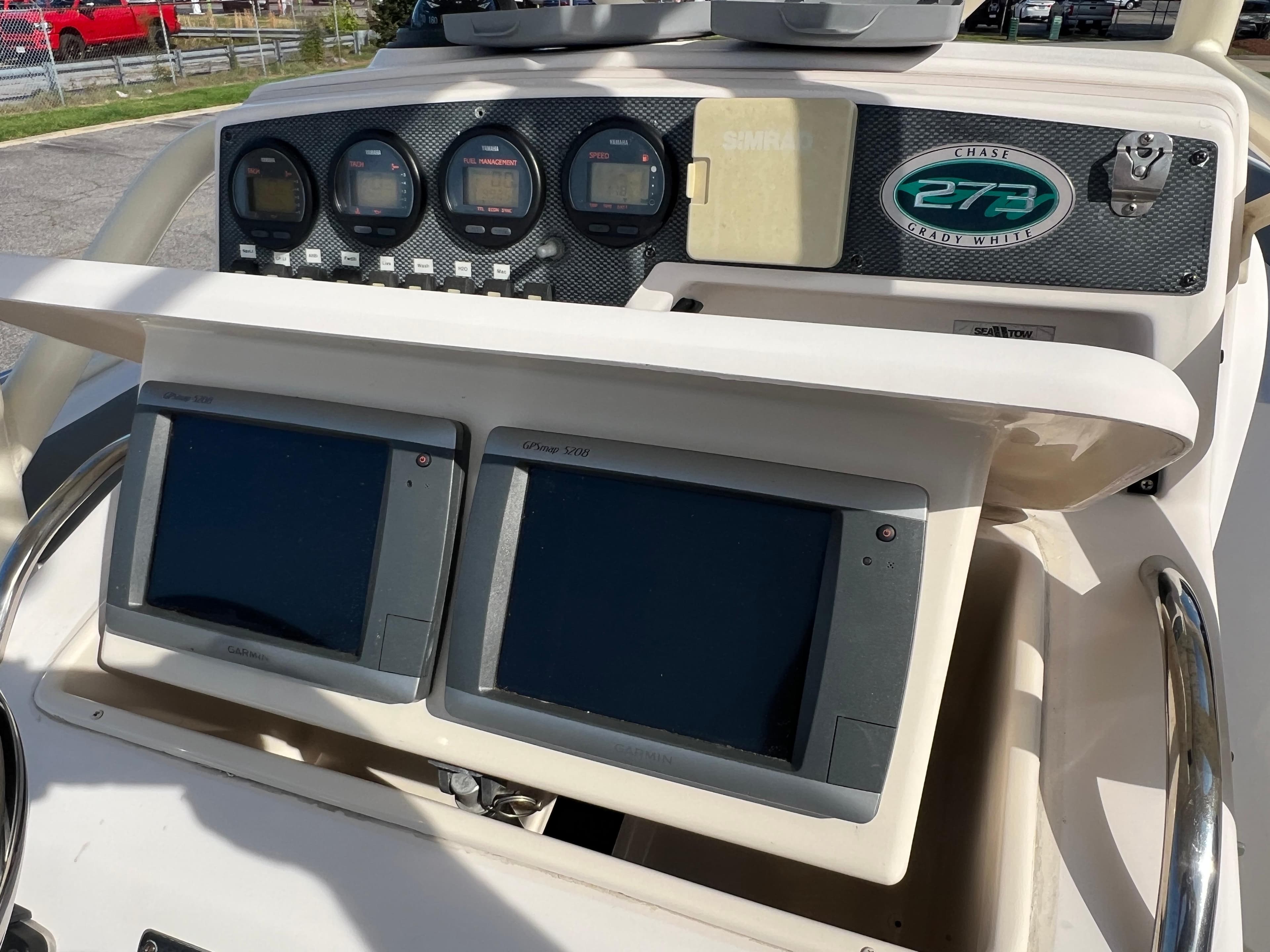 Console of 2002 Grady-White Chase 273 boat with navigation screens and gauges.