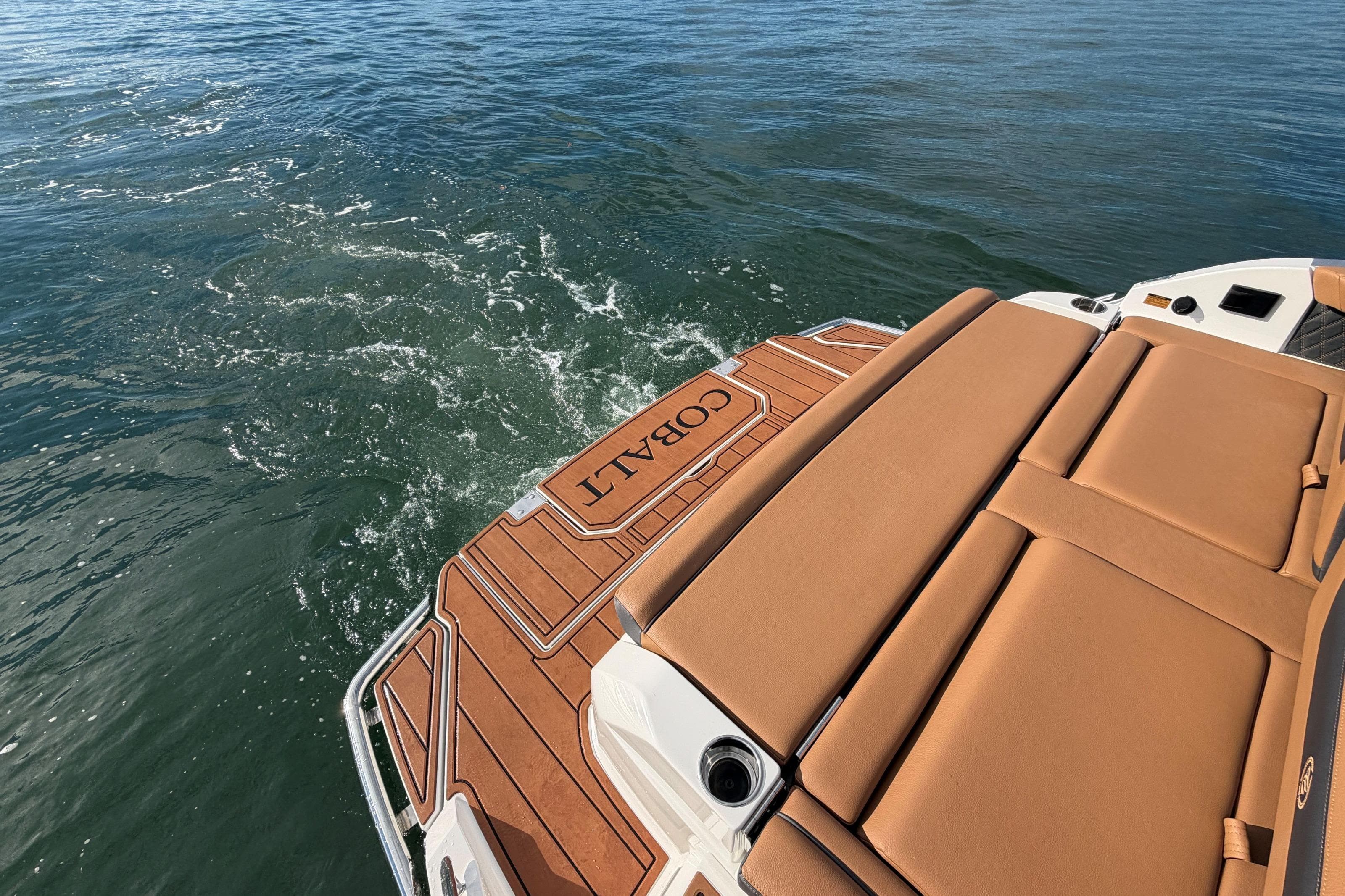 2026 Cobalt R31 boat with tan seating and teak deck on open water.