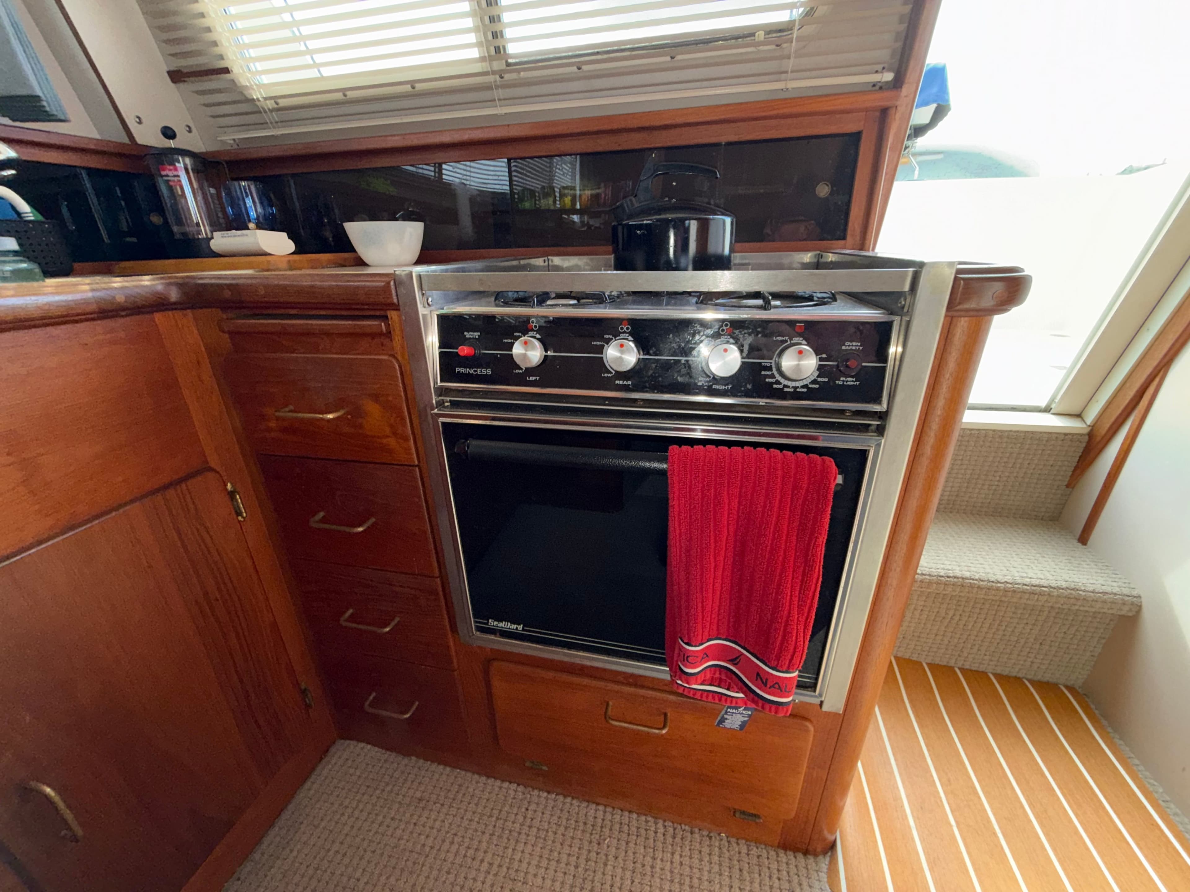 Interior of 1988 Tollycraft Sport Sedan with stove and cabinets.