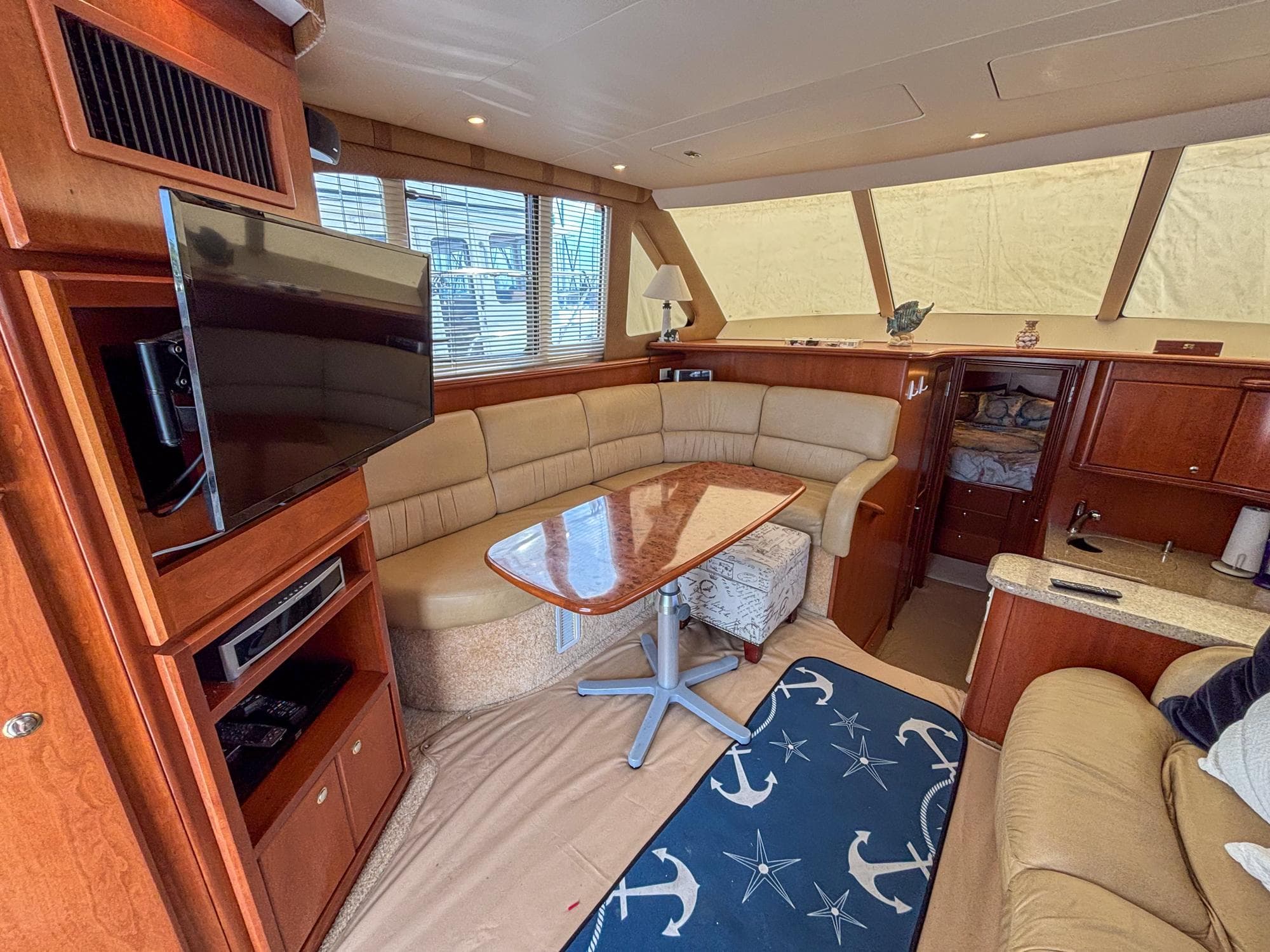 Luxurious interior of 2007 Silverton 38 Convertible yacht with cozy seating and modern amenities.