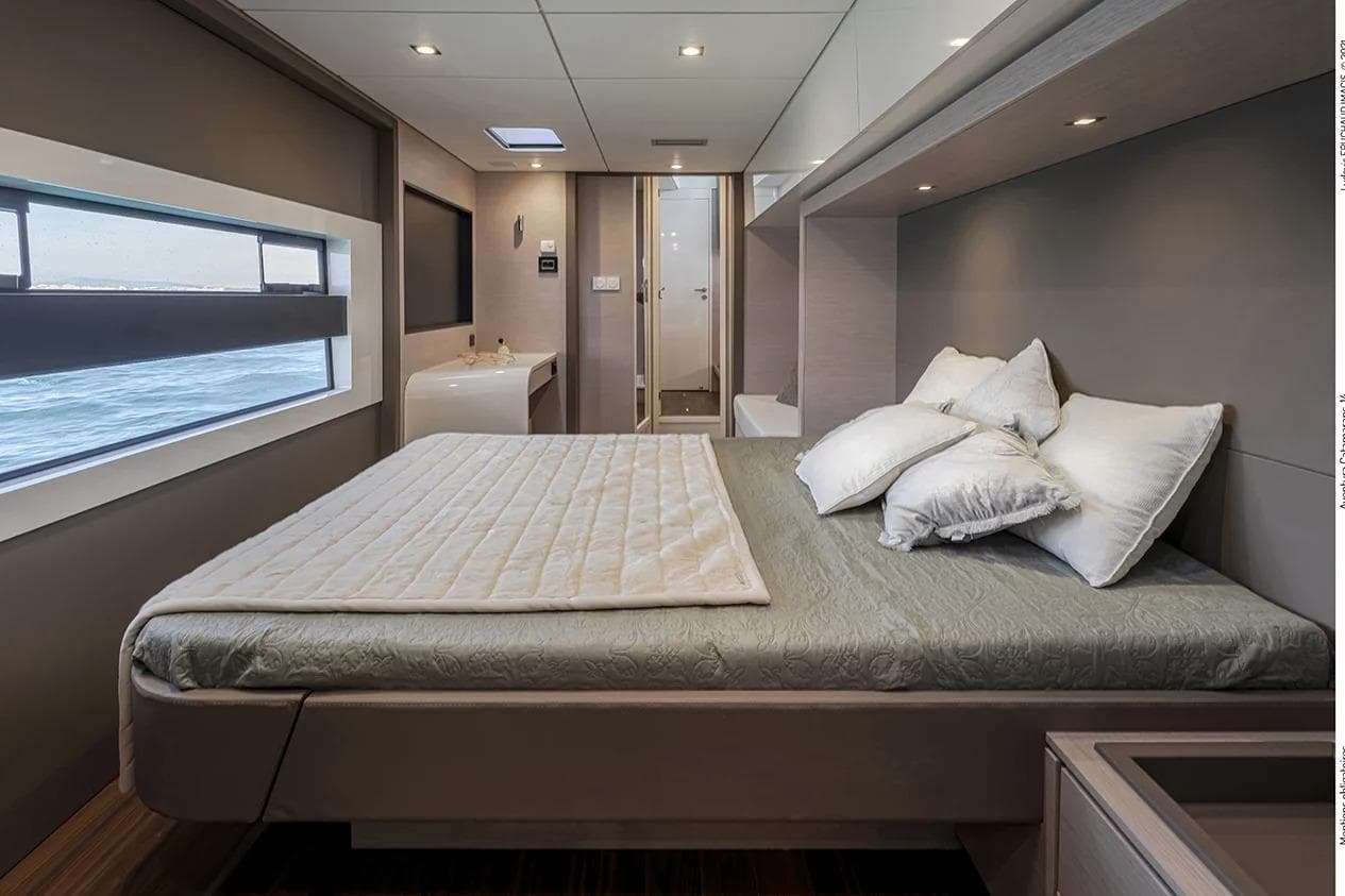 Luxurious bedroom interior of 2026 Aventura 56 Motor Yacht with ocean view window.
