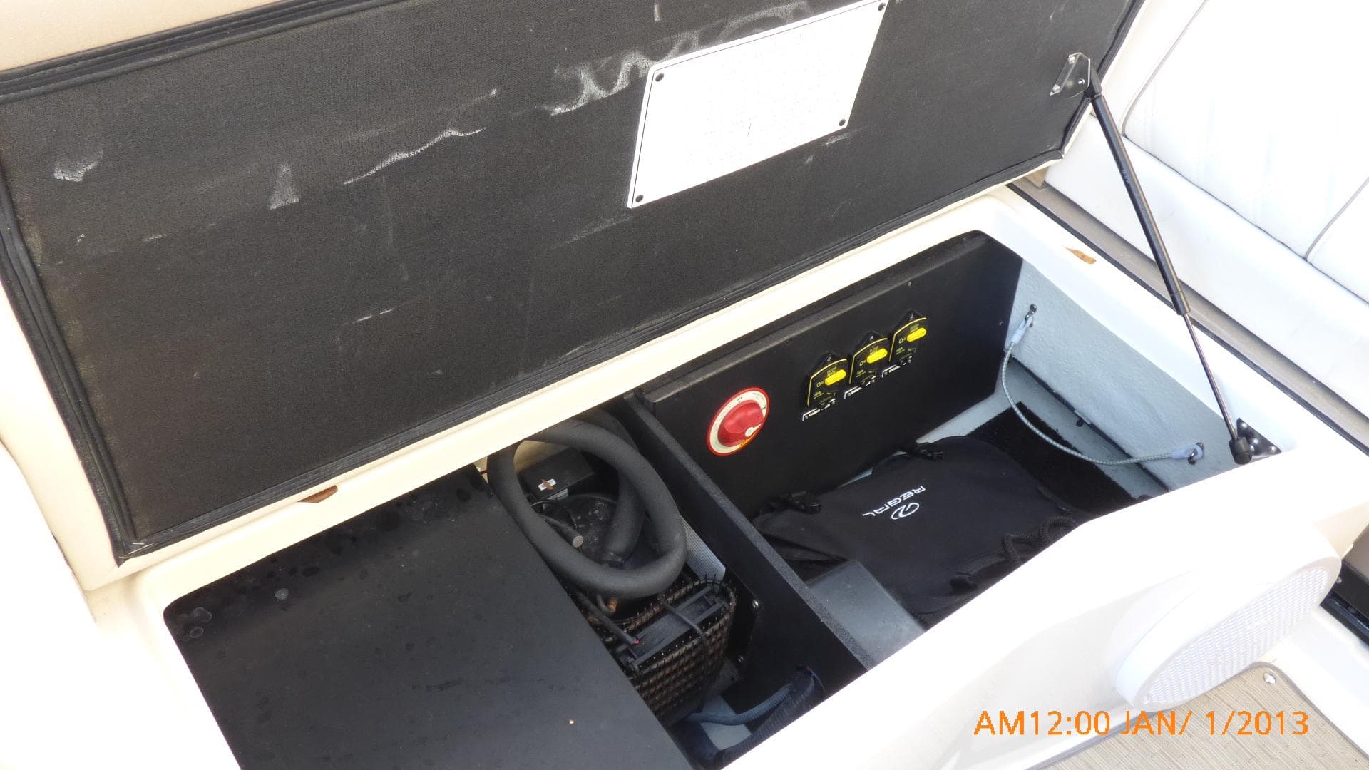Open engine compartment of 2018 Regal 28 Express boat, showing components and controls.