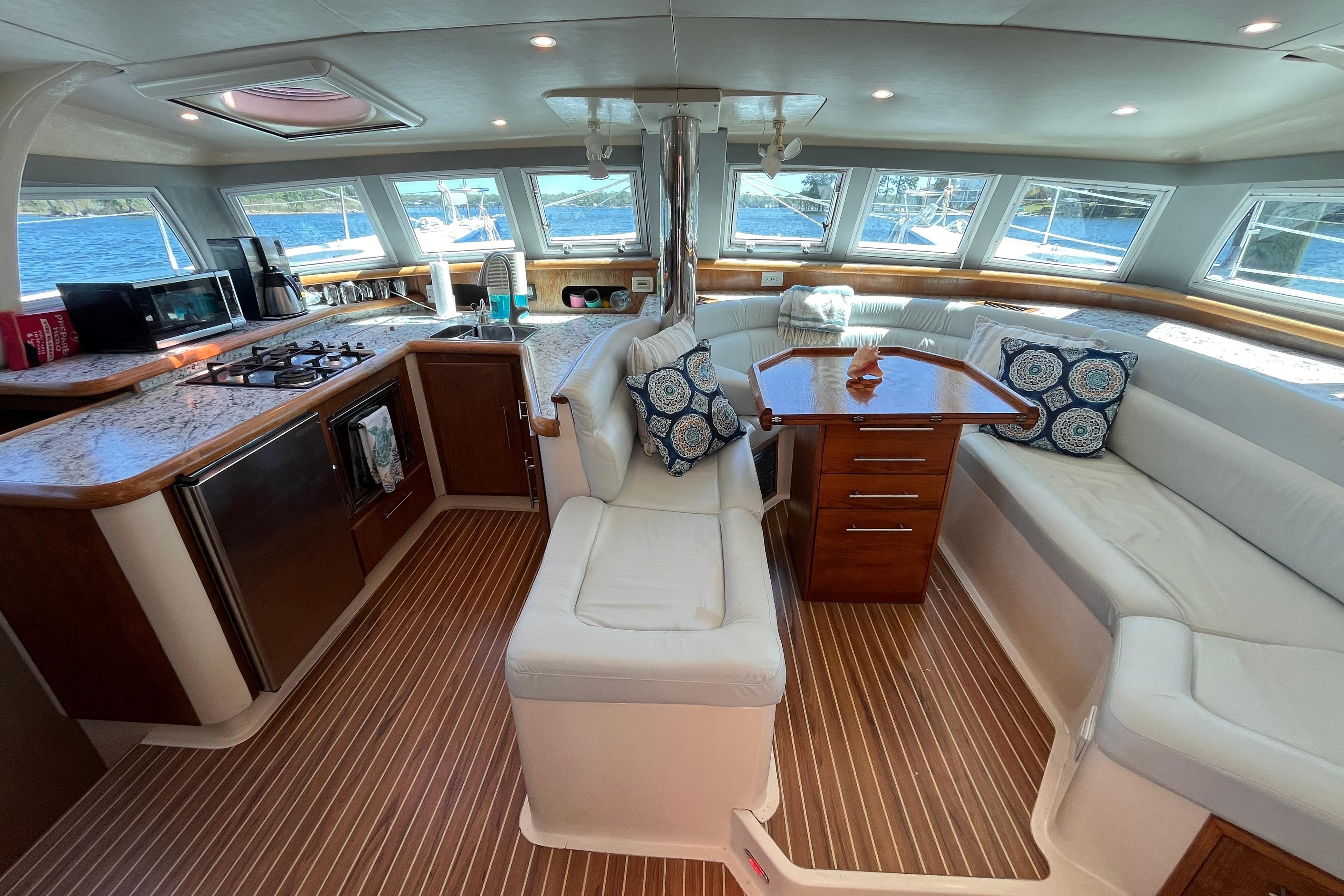 Luxurious interior of a 2008 Broadblue 415 catamaran with modern kitchen and seating area.