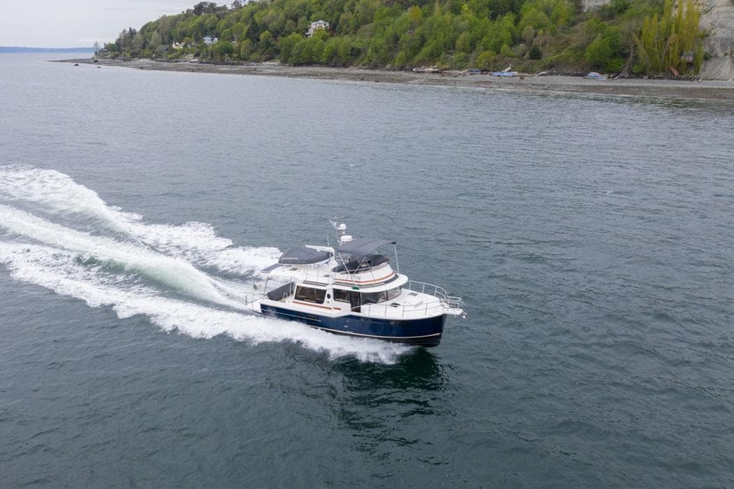 2025 Ranger Tugs 43 Command Bridge cruising on a scenic waterway.