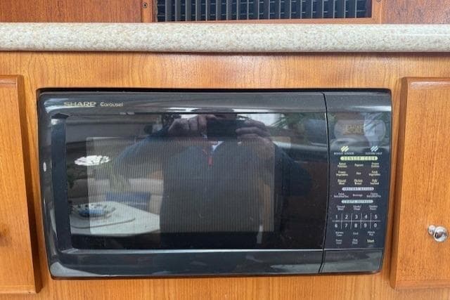 Microwave in Carver 406 Aft Cabin Motor Yacht, 2000 model, wooden cabinetry.