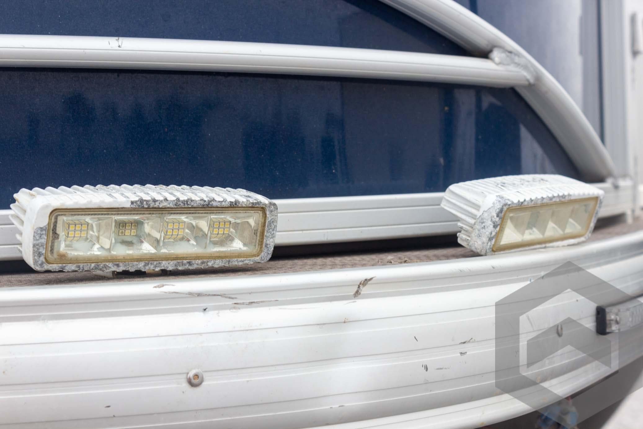 2020 Sun Tracker Fishin' Barge 22 DLX, close-up of LED lights on blue exterior.