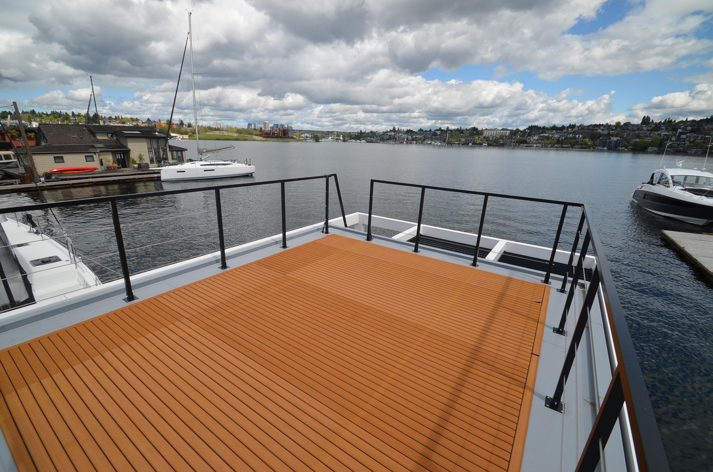 2024 La Mare Modern 11 houseboat with spacious deck overlooking serene lake.