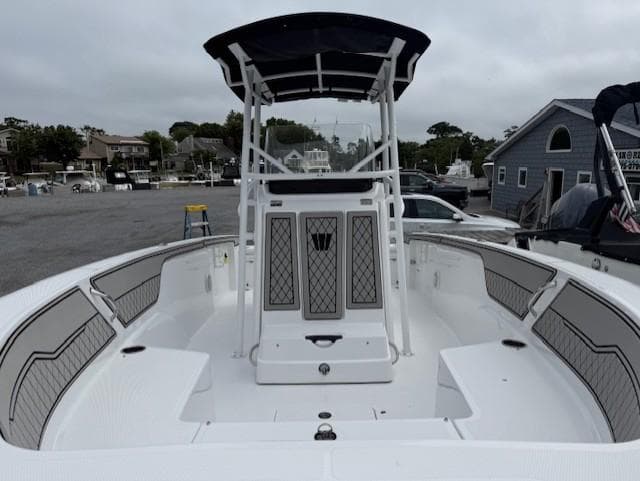 2025 Wellcraft 202 Fisherman boat with spacious deck and modern design in a marina setting.
