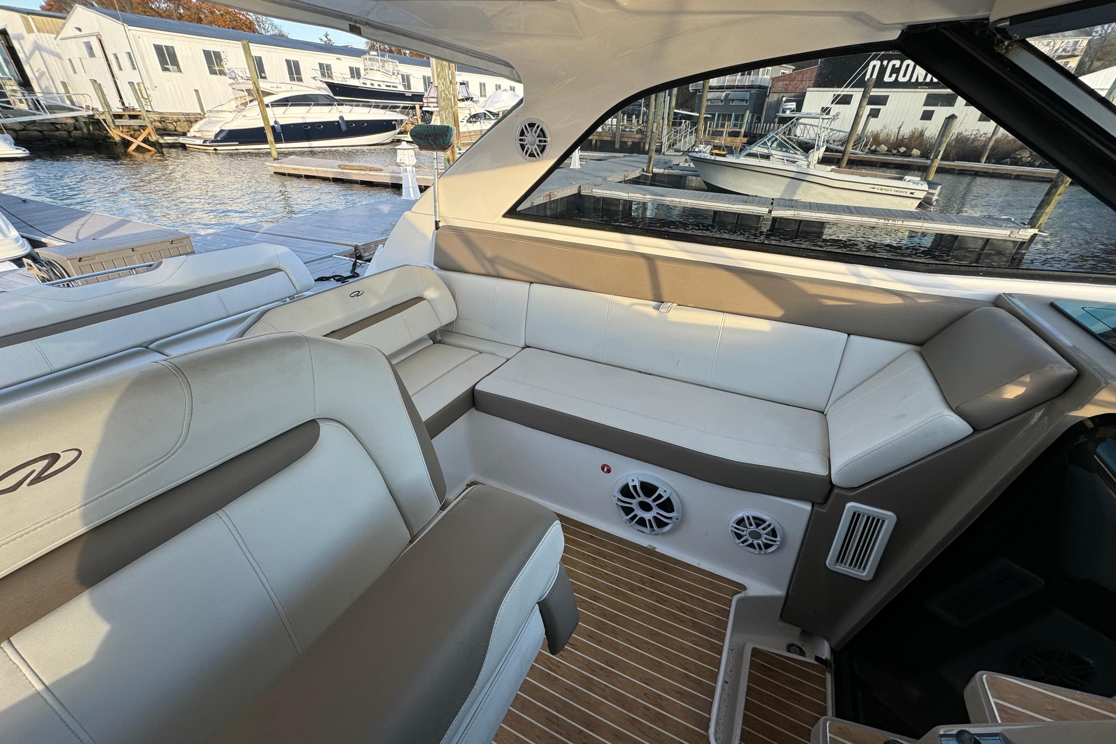 Interior of 2017 Regal 35 Sport Coupe with luxurious seating and waterfront view.
