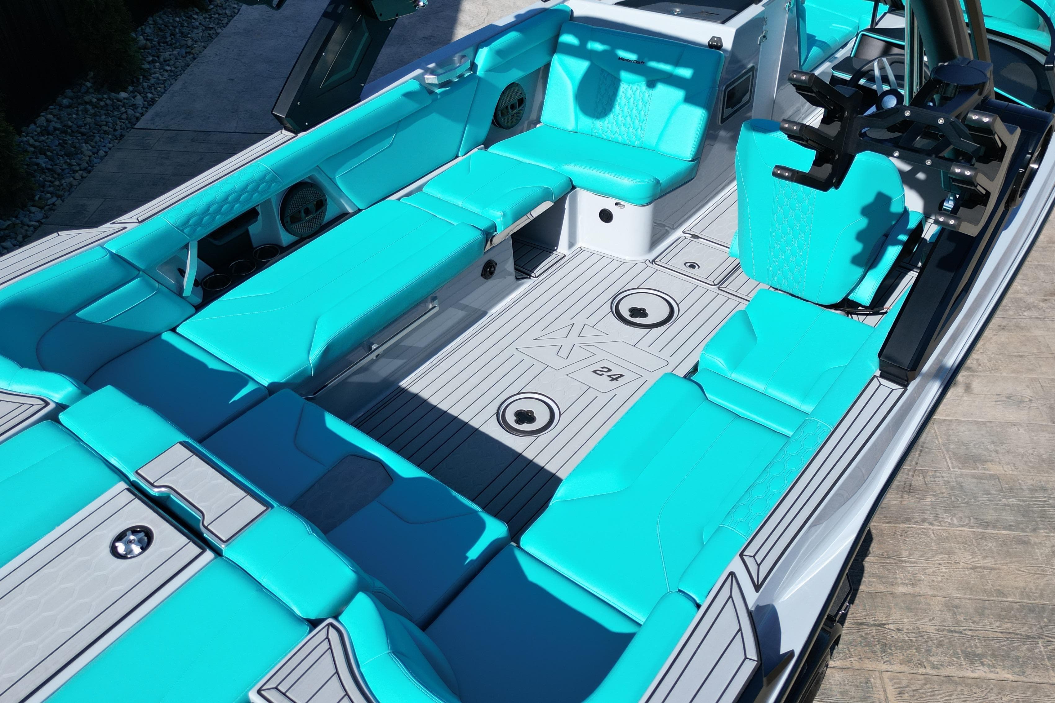 2025 MasterCraft XT24 boat interior with turquoise seating and sleek design.