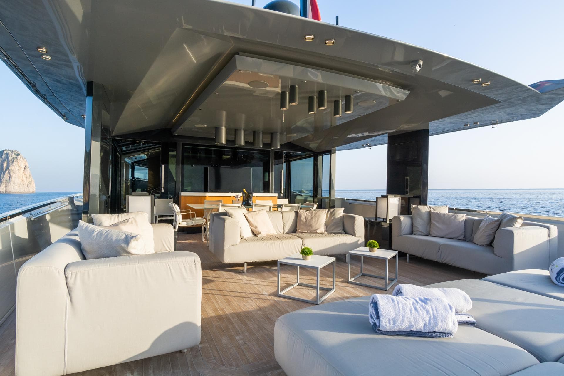 Luxurious 2019 Arcadia A85 yacht deck with elegant seating and ocean view.