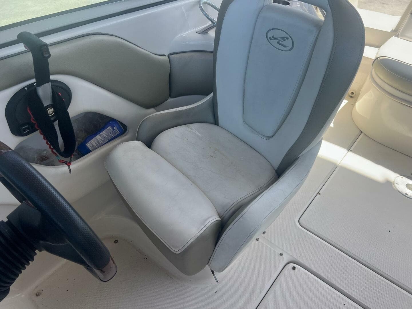 2007 Sea Ray 240 Sundeck interior with steering wheel and cushioned seat.