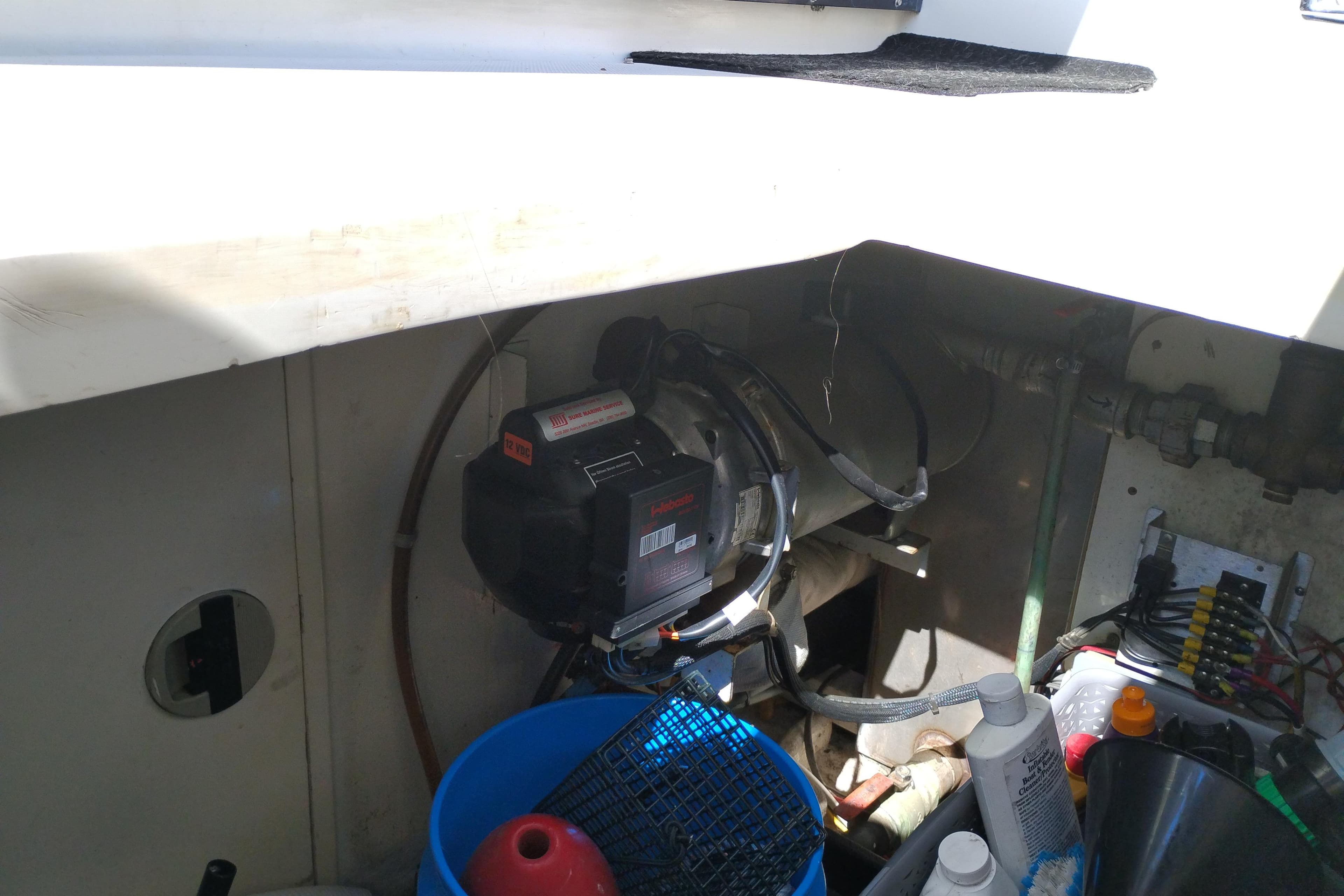 Engine compartment of a 1997 Symbol 50 Pilothouse boat with maintenance supplies.