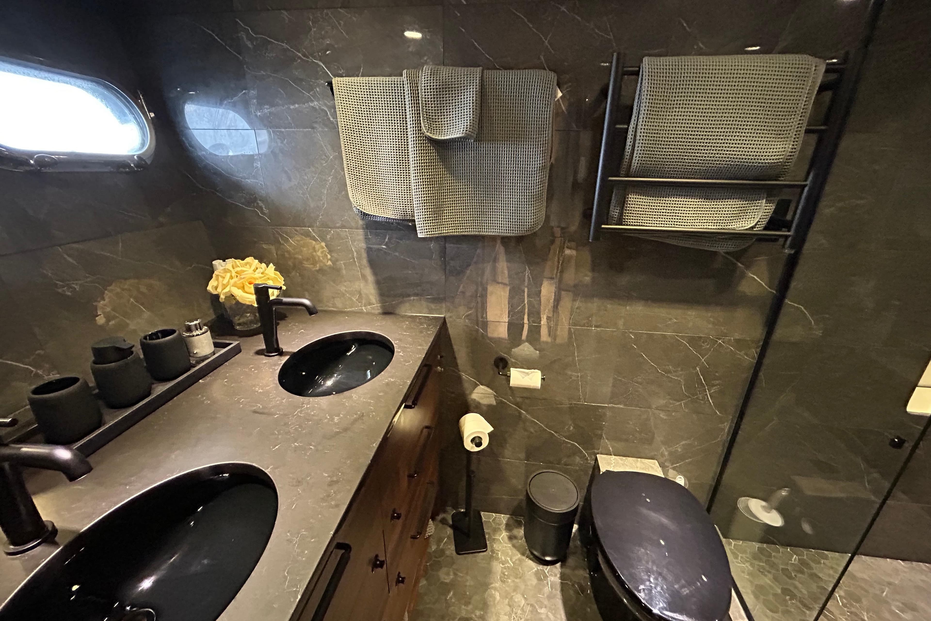 Luxurious bathroom in 2002 Cheoy Lee 66 Pilothouse yacht with dual sinks and modern fixtures.