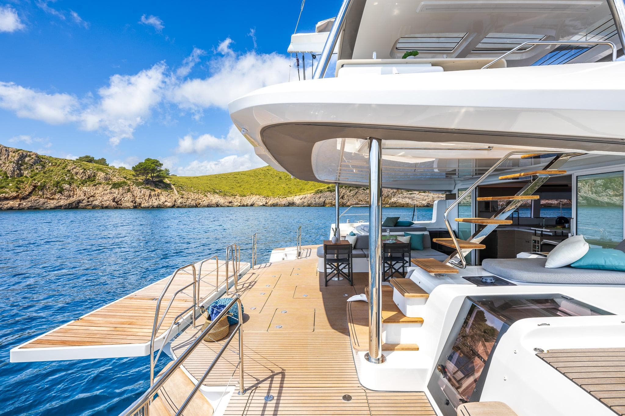 Luxurious 2025 Lagoon 60 yacht with spacious deck, scenic ocean view, and modern amenities.