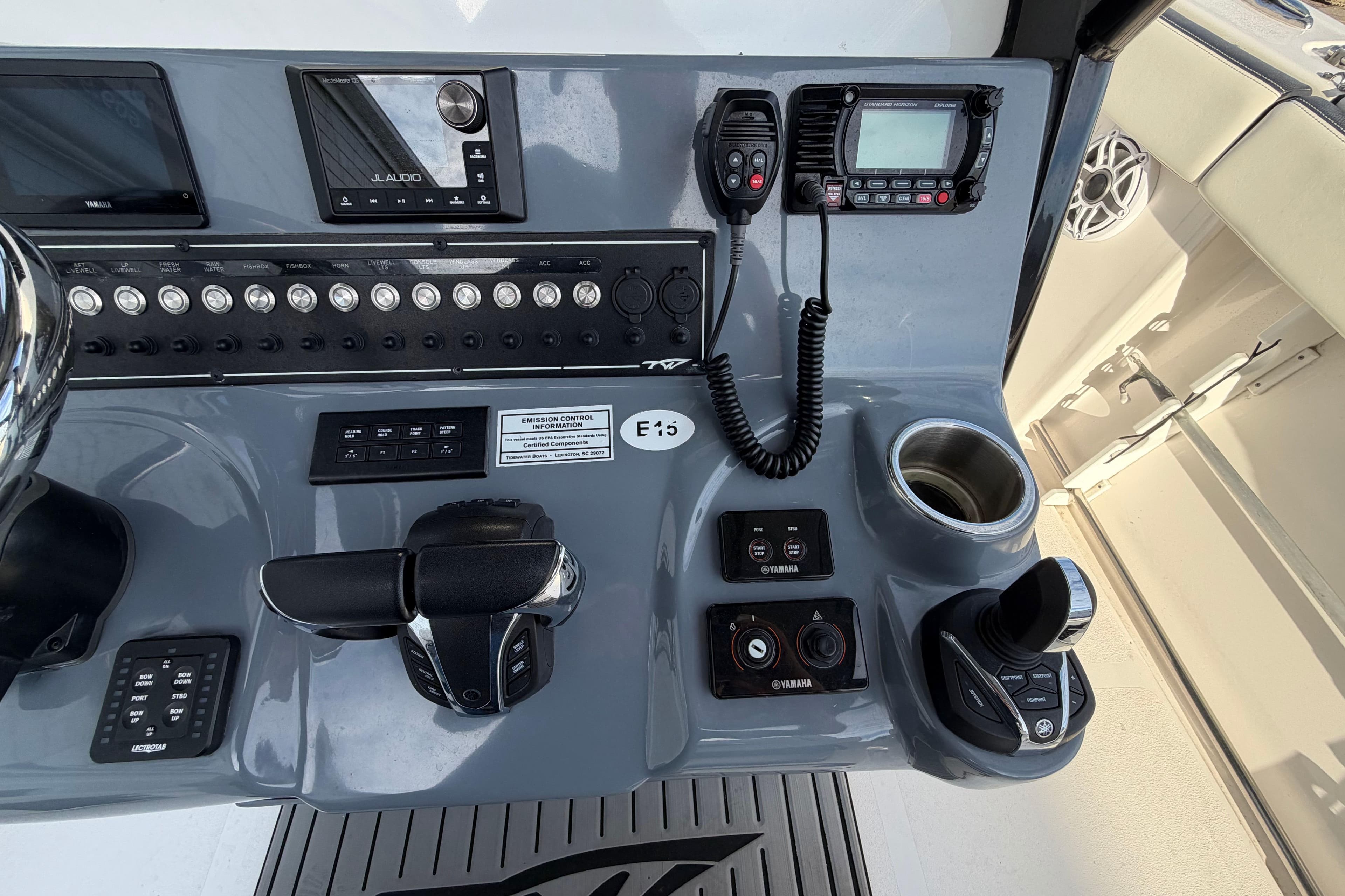 Control panel of 2023 Tidewater 282 CC Adventure Bluewater boat with navigation and communication equipment.