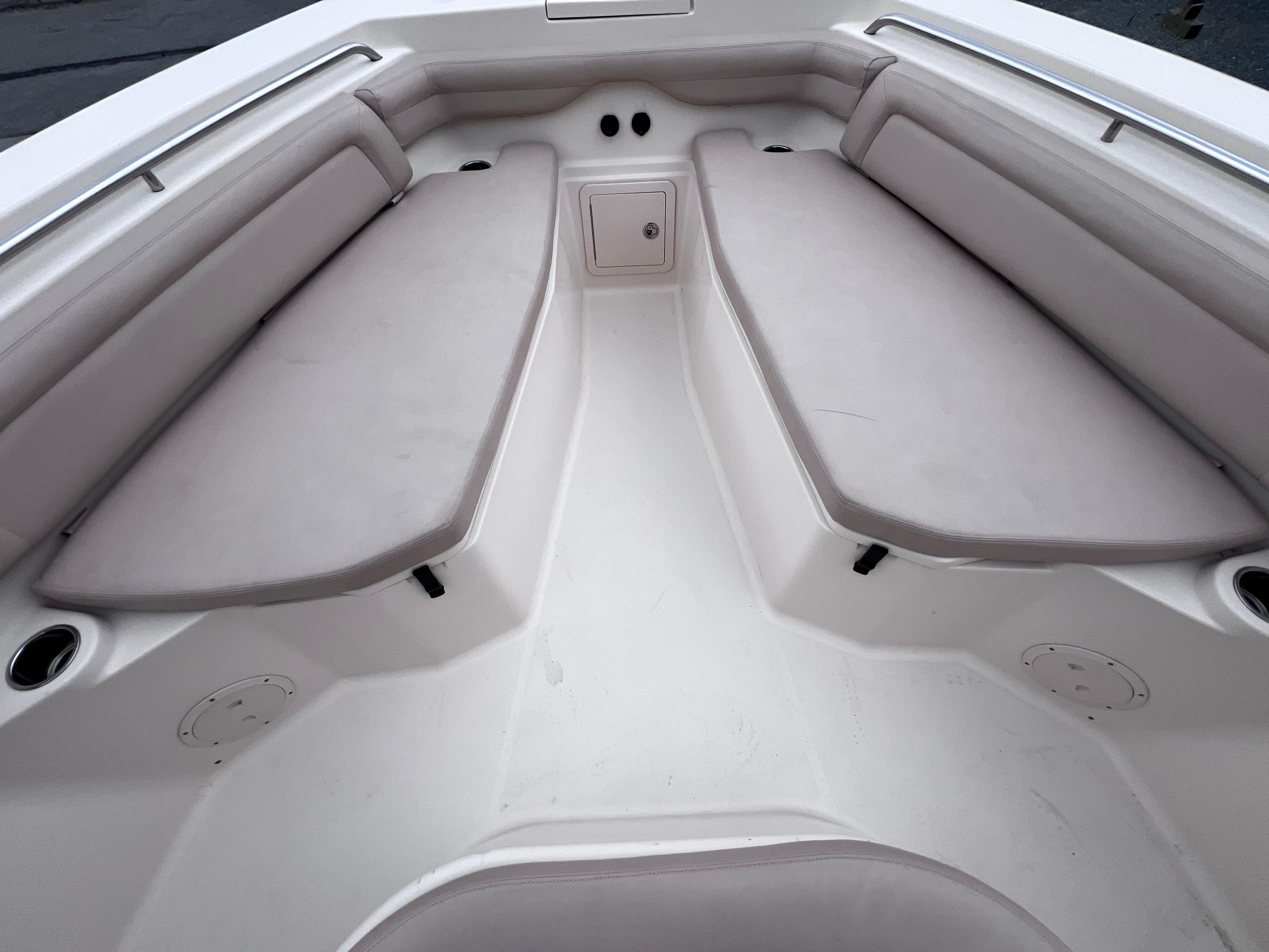 2015 Grady-White 336 Canyon boat interior with cushioned seating and storage compartment.