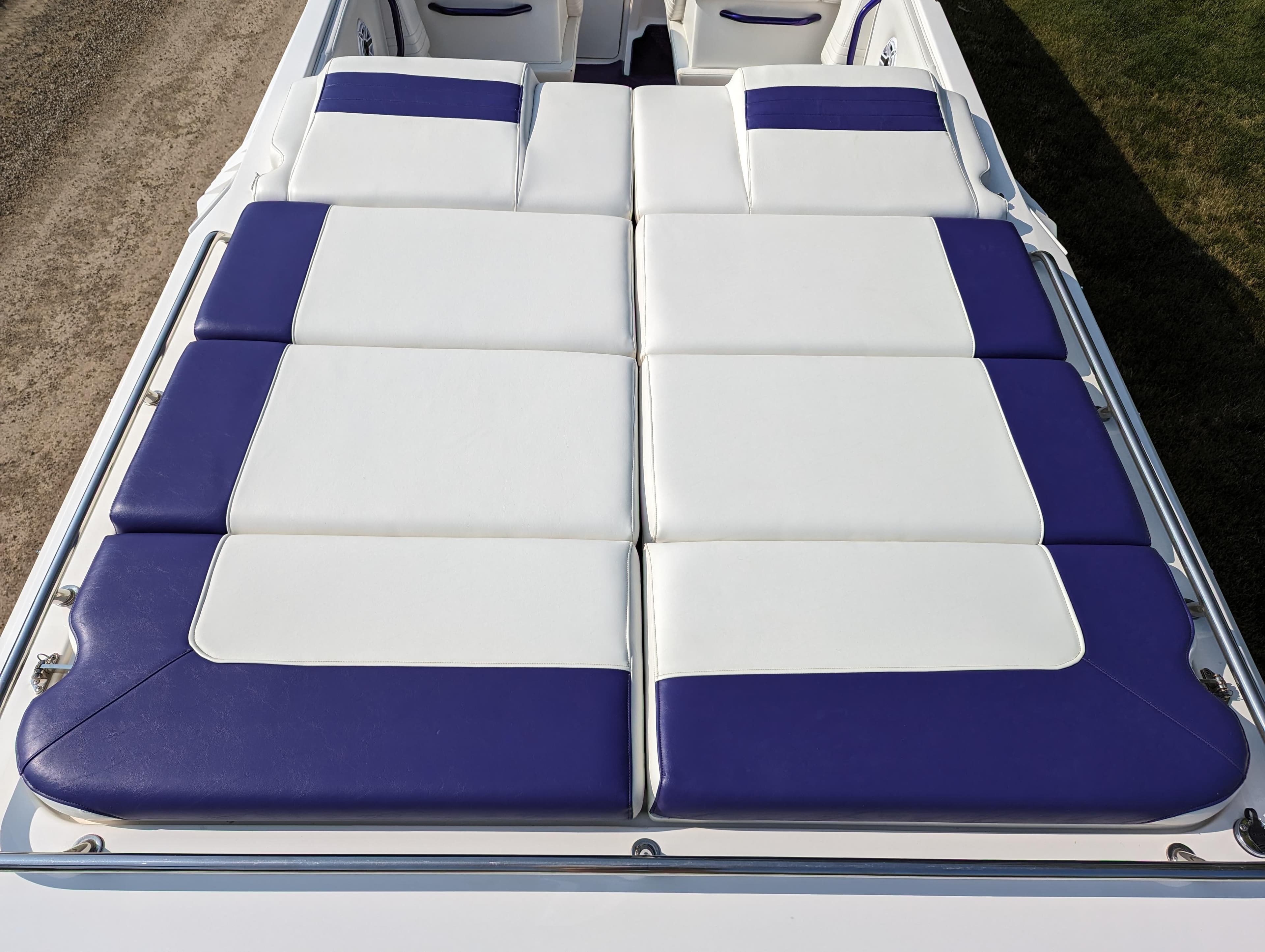 2006 Fountain 42 boat with white and purple cushioned seating.
