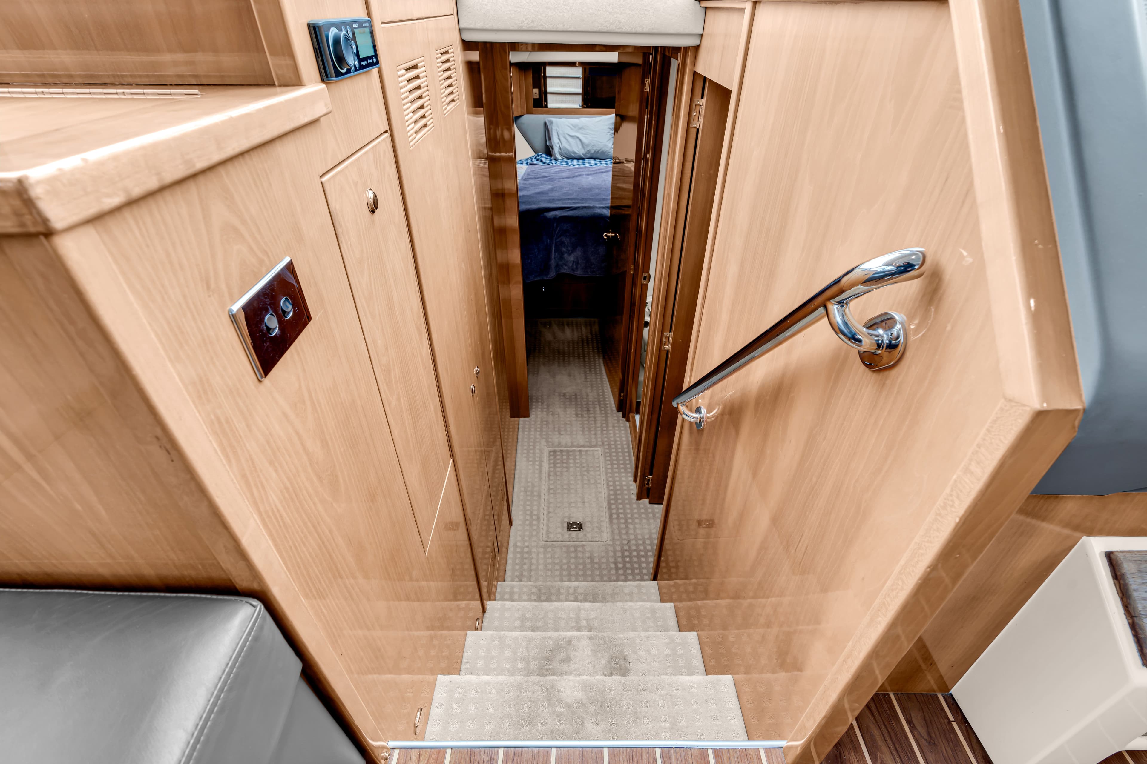 Interior of 2014 Riviera 44 Sport Yacht with stairs and cabin.