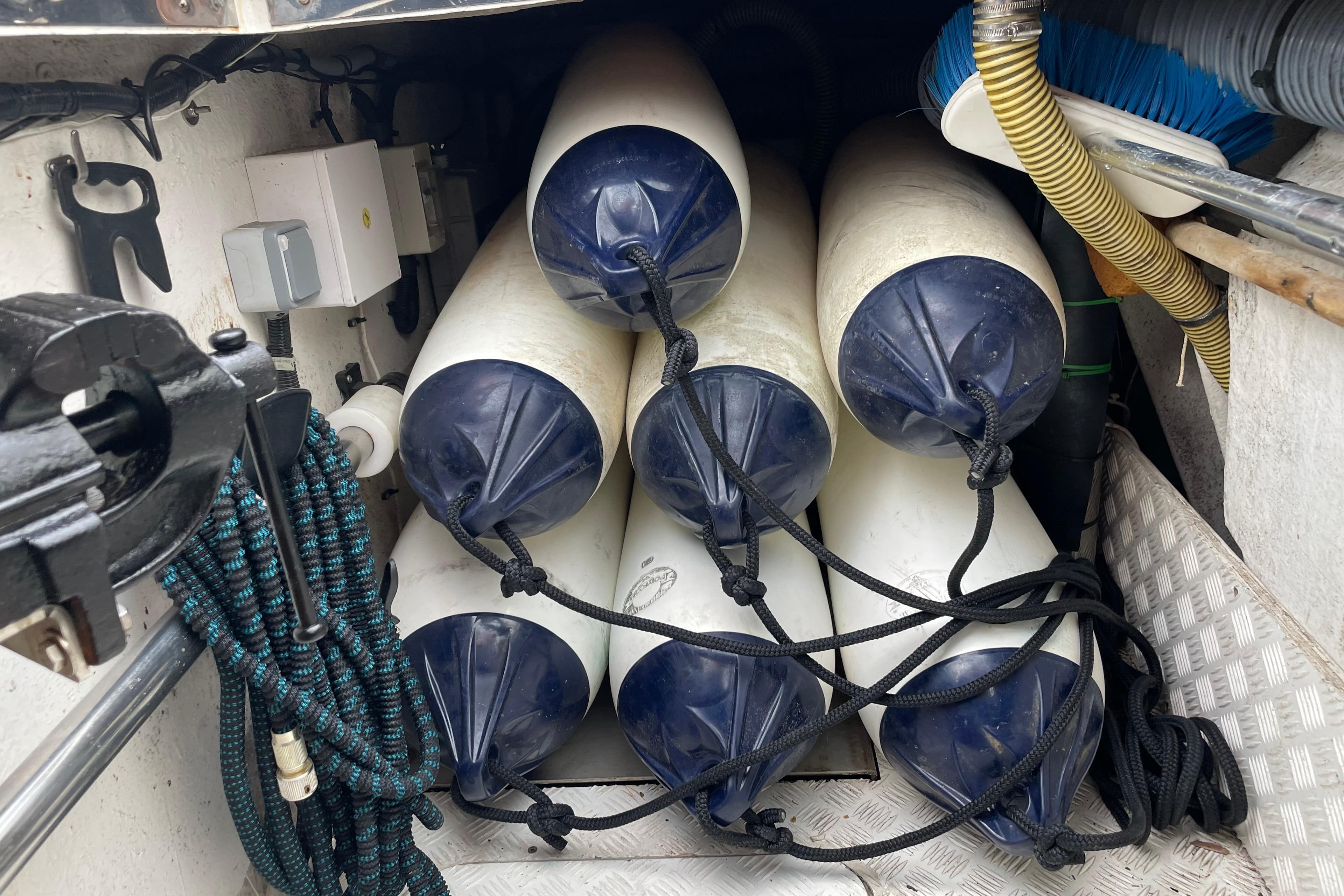 Boat fenders stored in a compartment of a 2004 Moody 56 yacht.