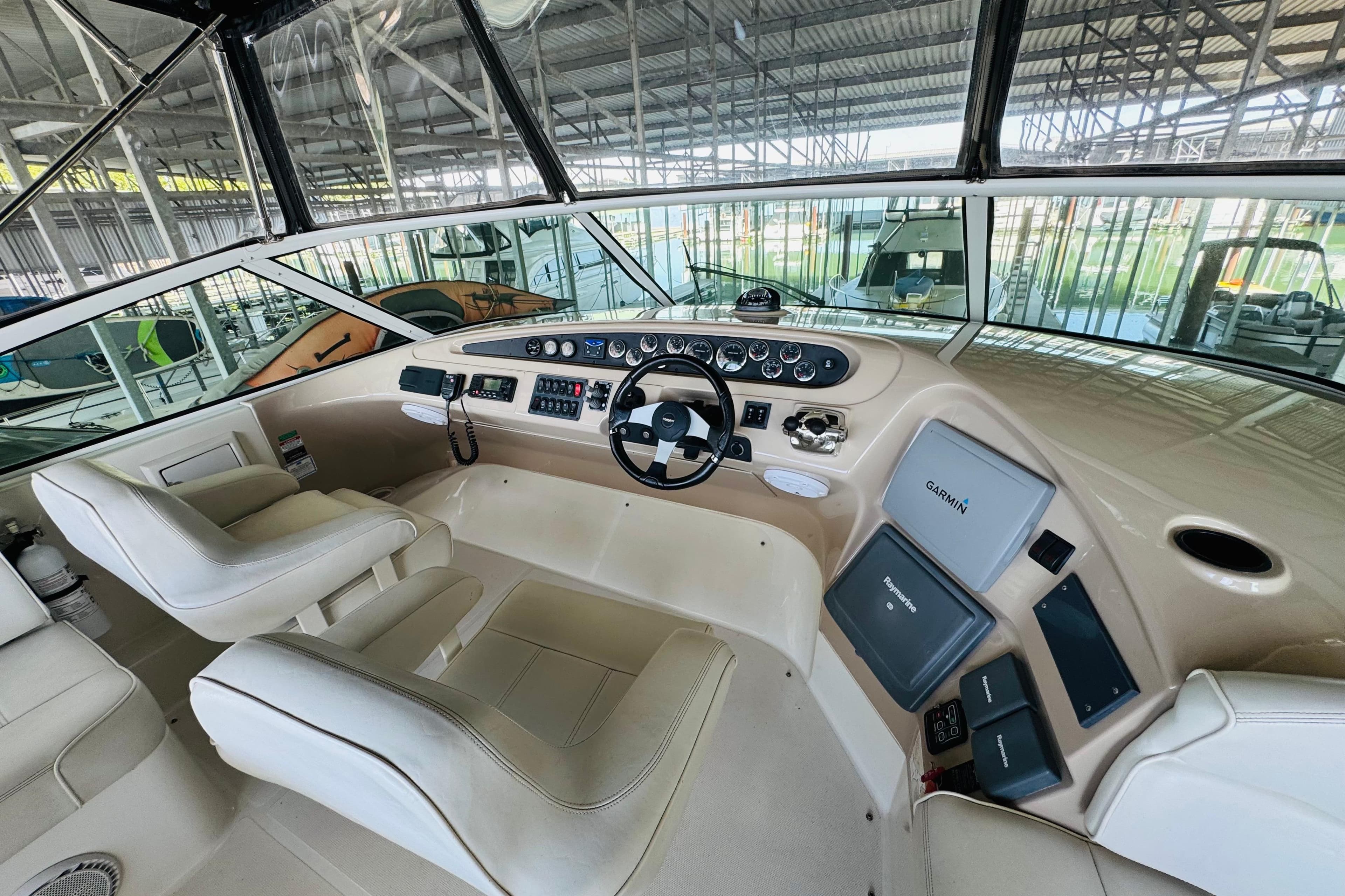 Interior of 2006 Carver 46 Voyager yacht with modern navigation equipment and plush seating.