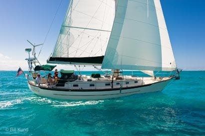 Sailing yacht Pacific Seacraft 40, 2025 model, cruising on clear turquoise waters.