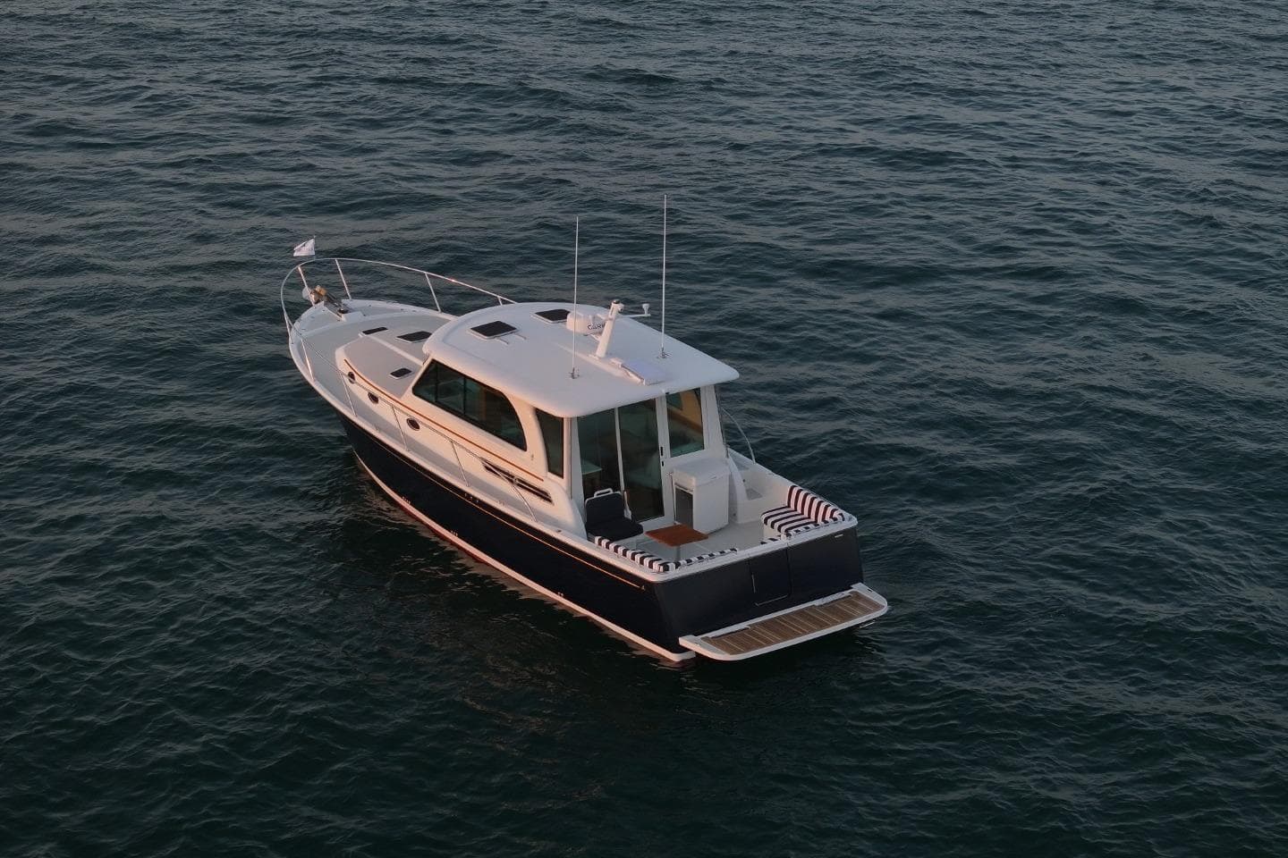 2026 Back Cove 412 yacht on calm ocean waters, aerial view.