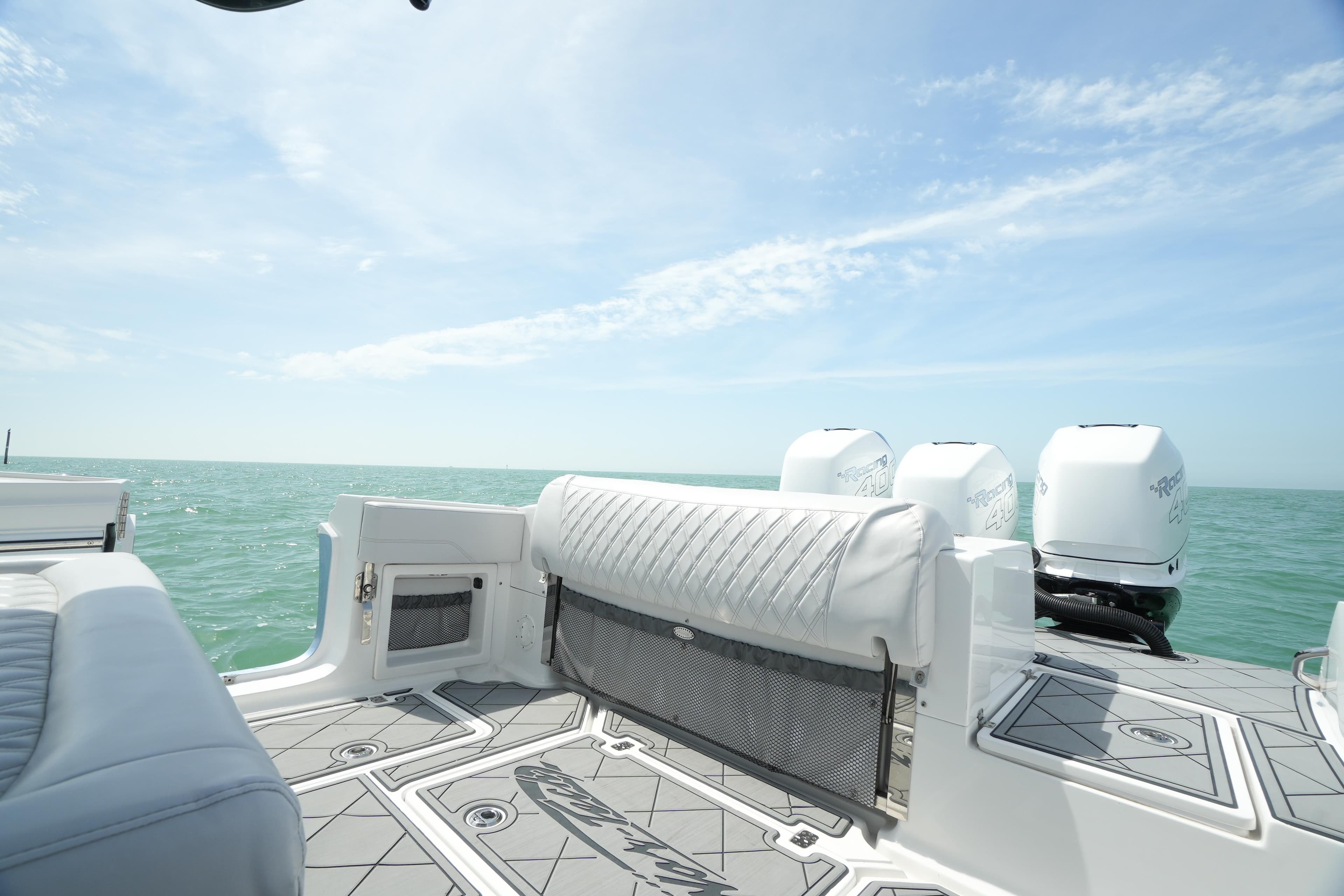 2020 Nor-Tech 390 Sport Center Console boat with ocean view and triple outboard engines.