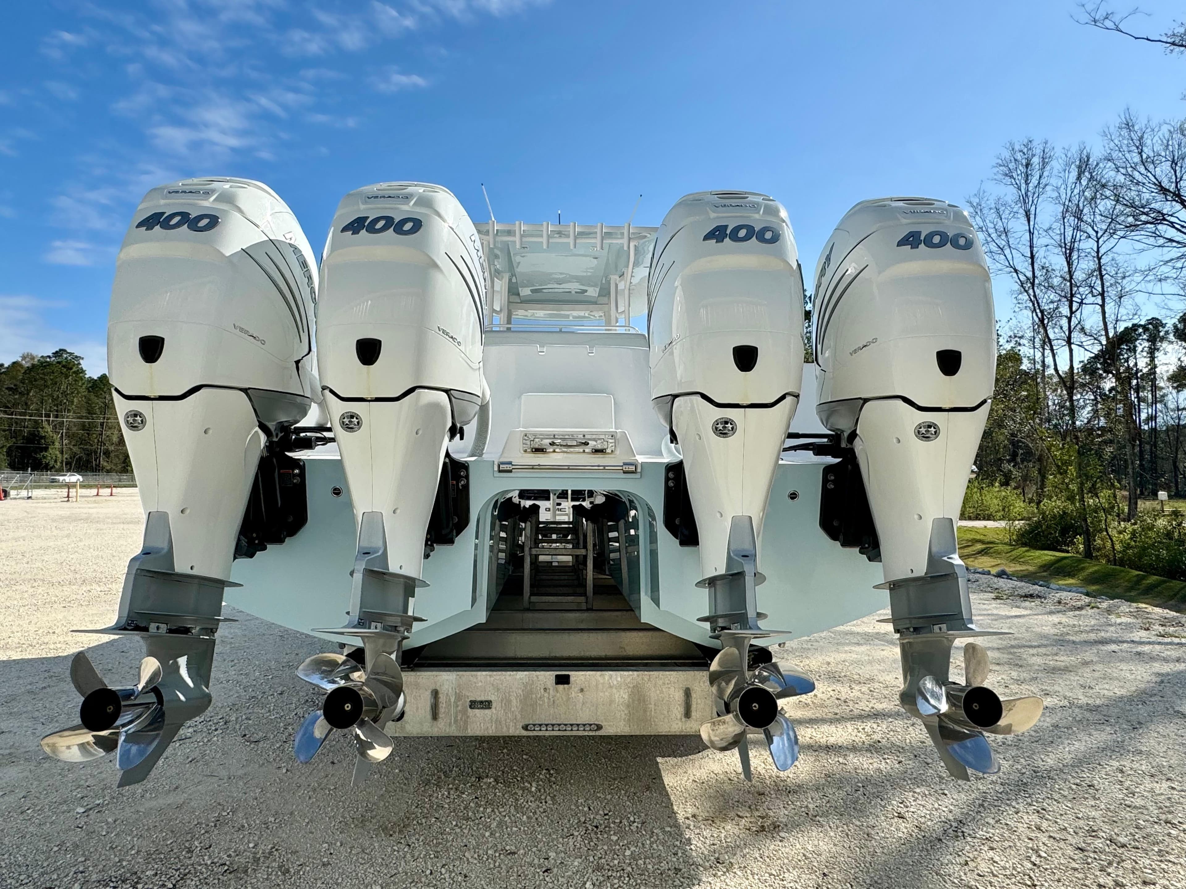 2020 Invincible 37 Catamaran with four powerful outboard engines, parked outdoors.