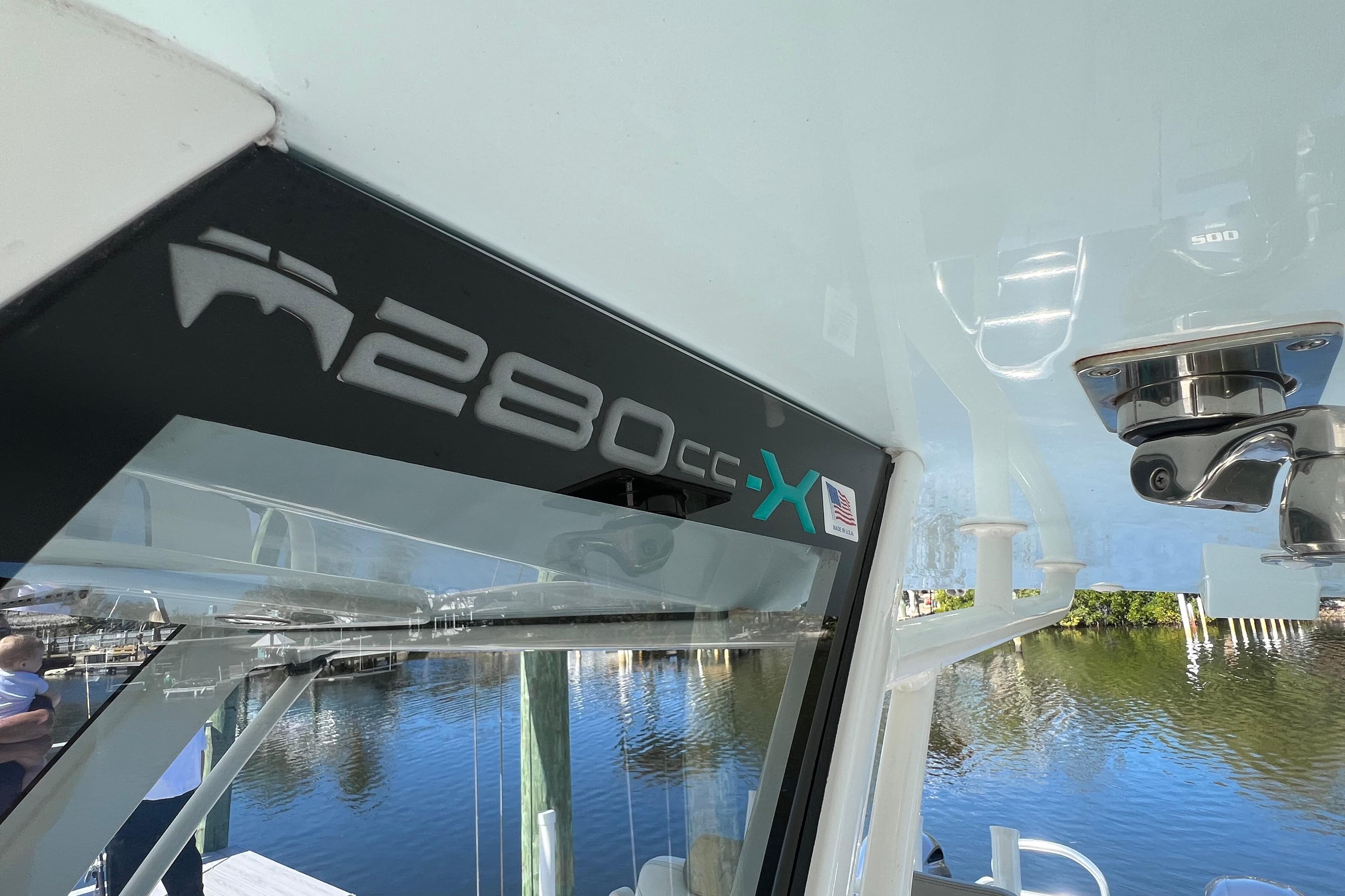 2022 World Cat 280 CC-X boat detail with logo, docked by the water.