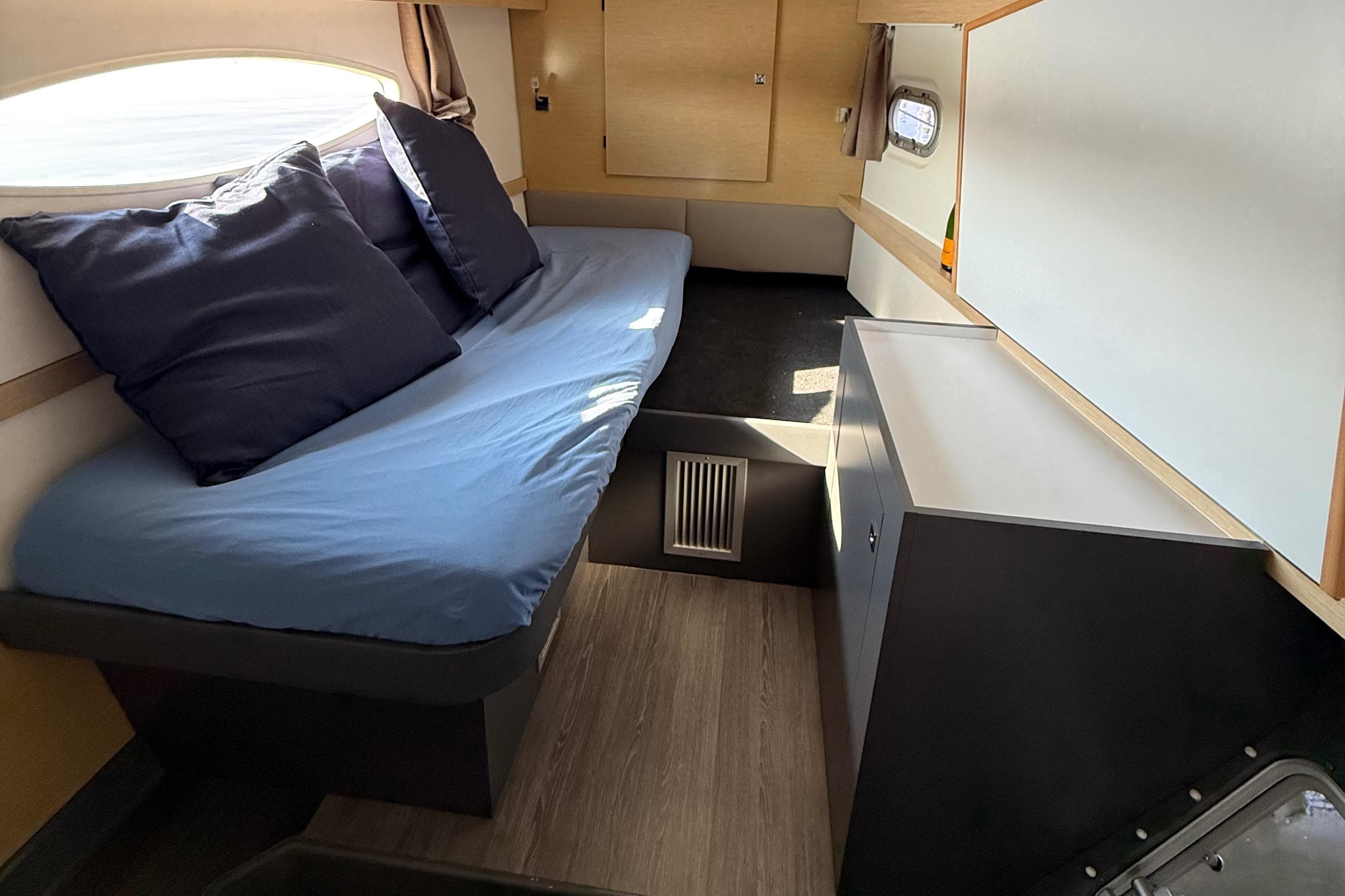 Interior cabin of 2015 Fountaine Pajot Helia 44 catamaran with cozy seating and storage.