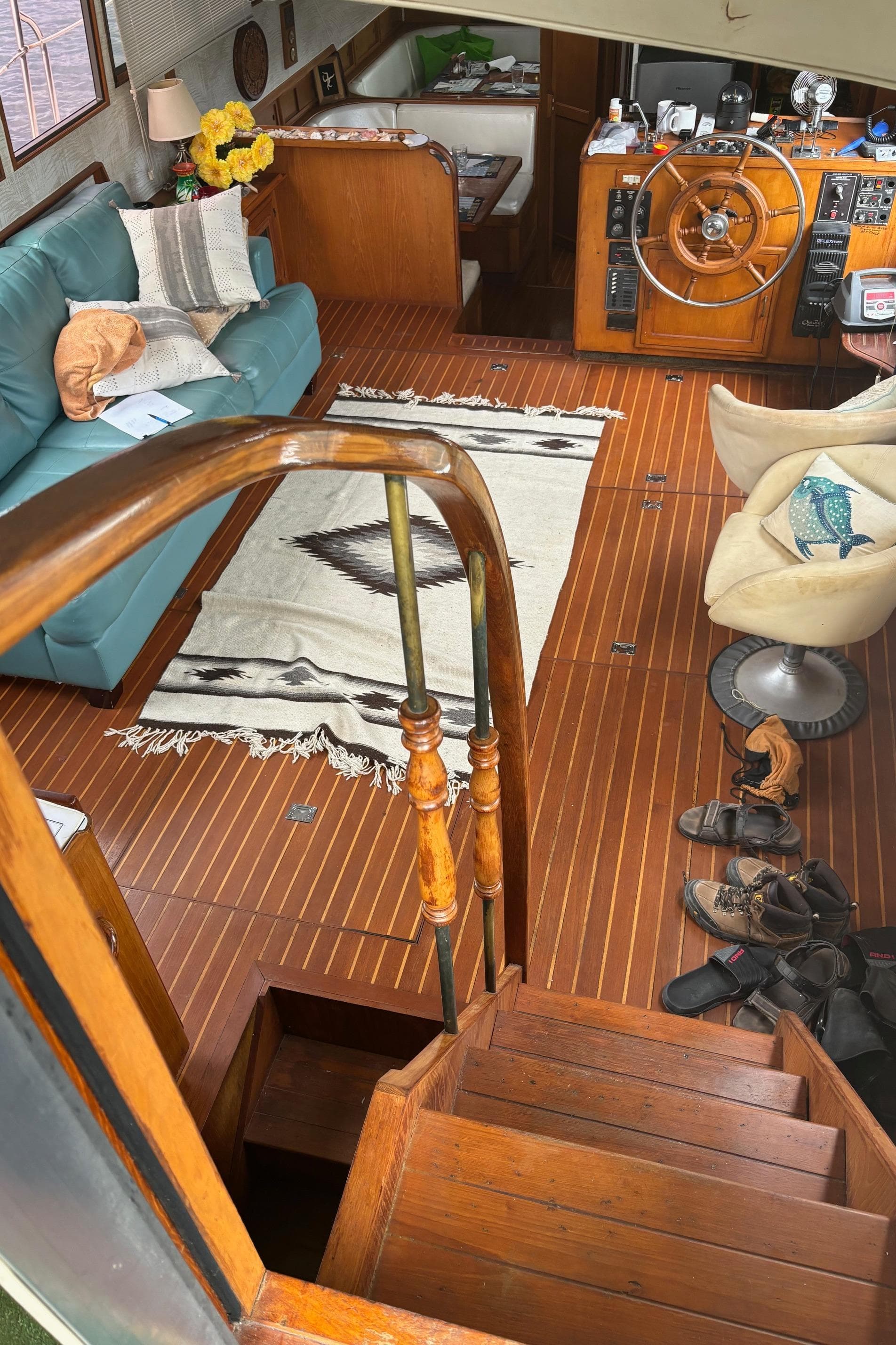 Interior of a 1987 Symbol 51 yacht with wooden flooring and cozy seating area.