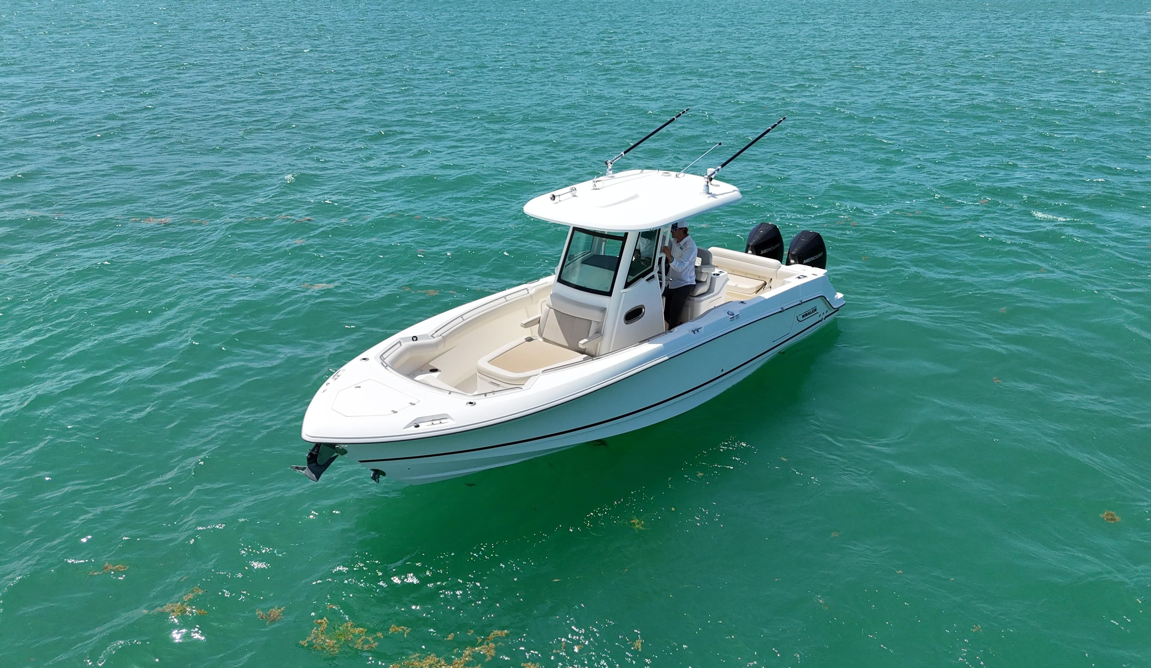 2022 Boston Whaler 280 Outrage boat on clear turquoise water.