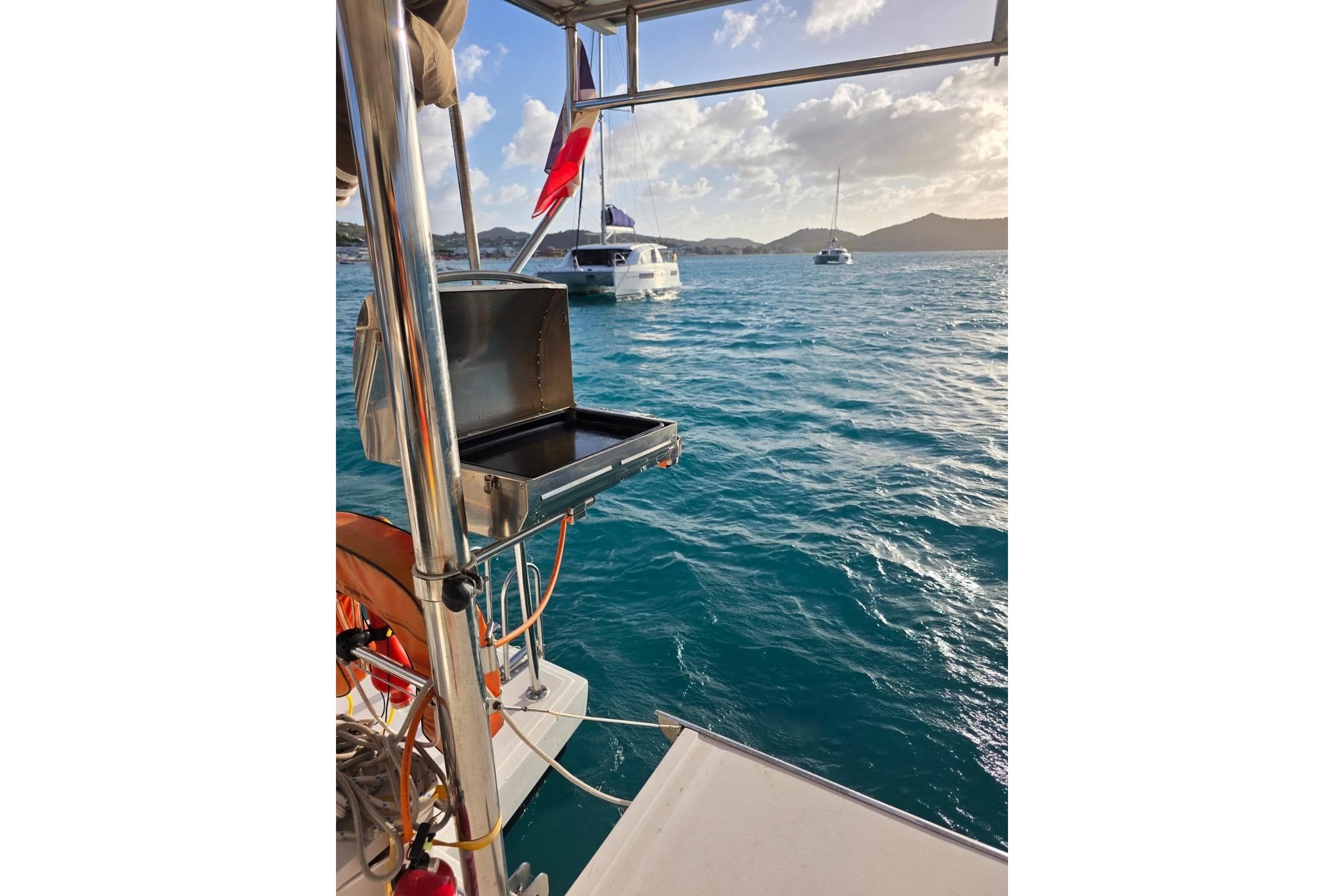 Sailing on a 2016 Bali 4.5 catamaran with a scenic ocean view and onboard grill.