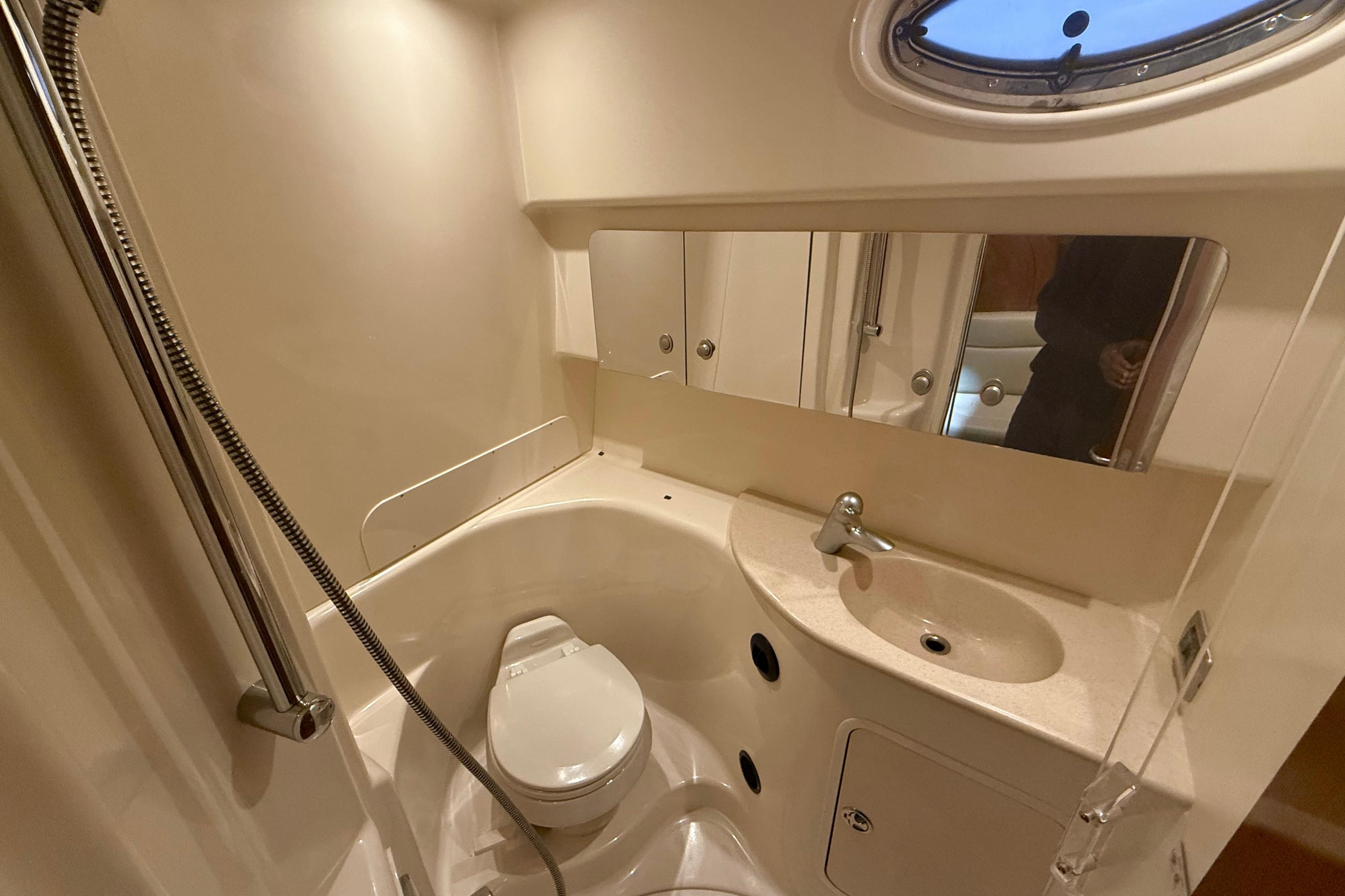 2004 Searay 360 Sundancer bathroom with shower, sink, and toilet.