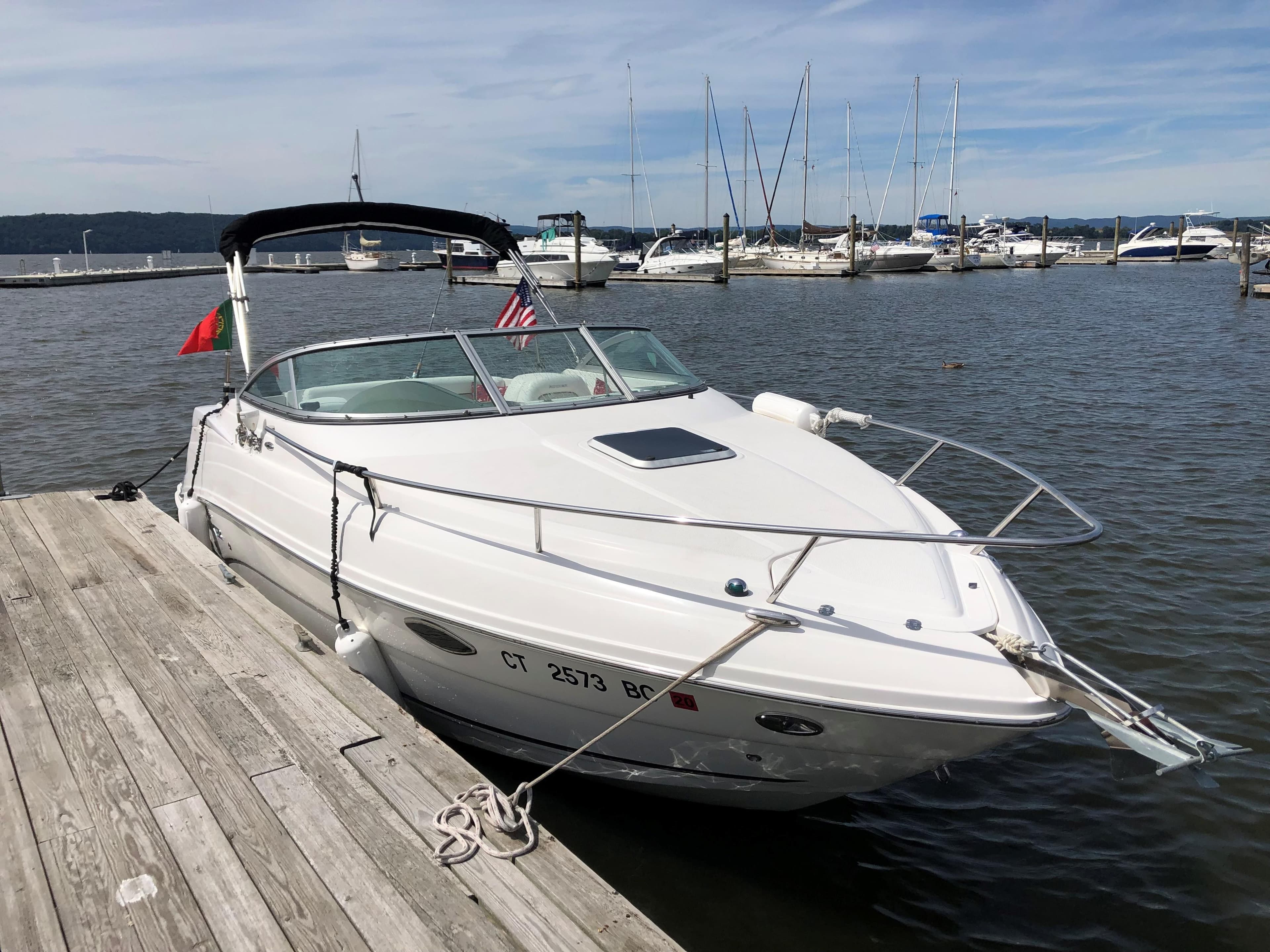 2008 Rinker 230 Captiva boat docked at a marina with other boats.