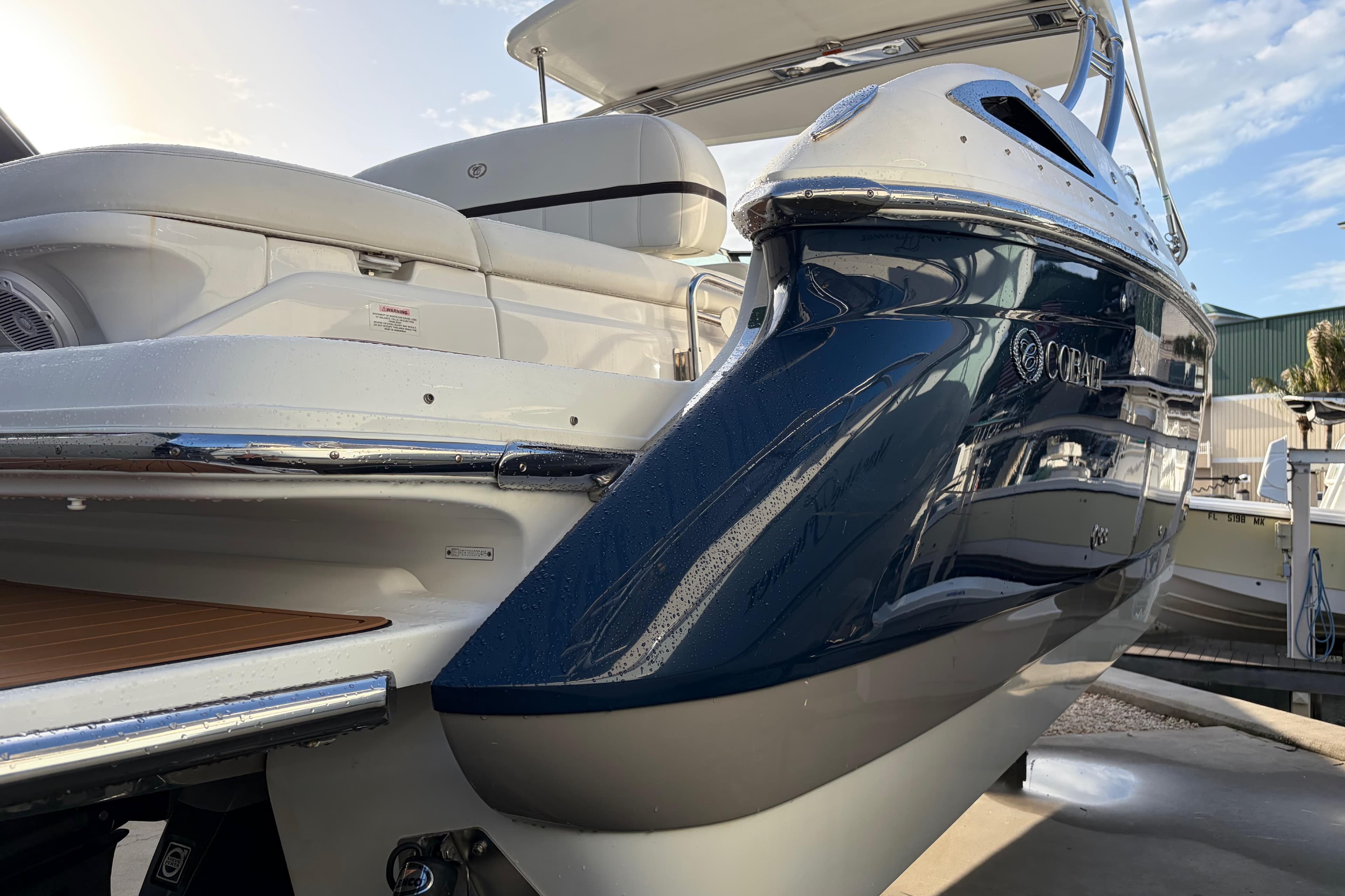2015 Cobalt 336 boat with sleek design and luxurious seating, docked outdoors.