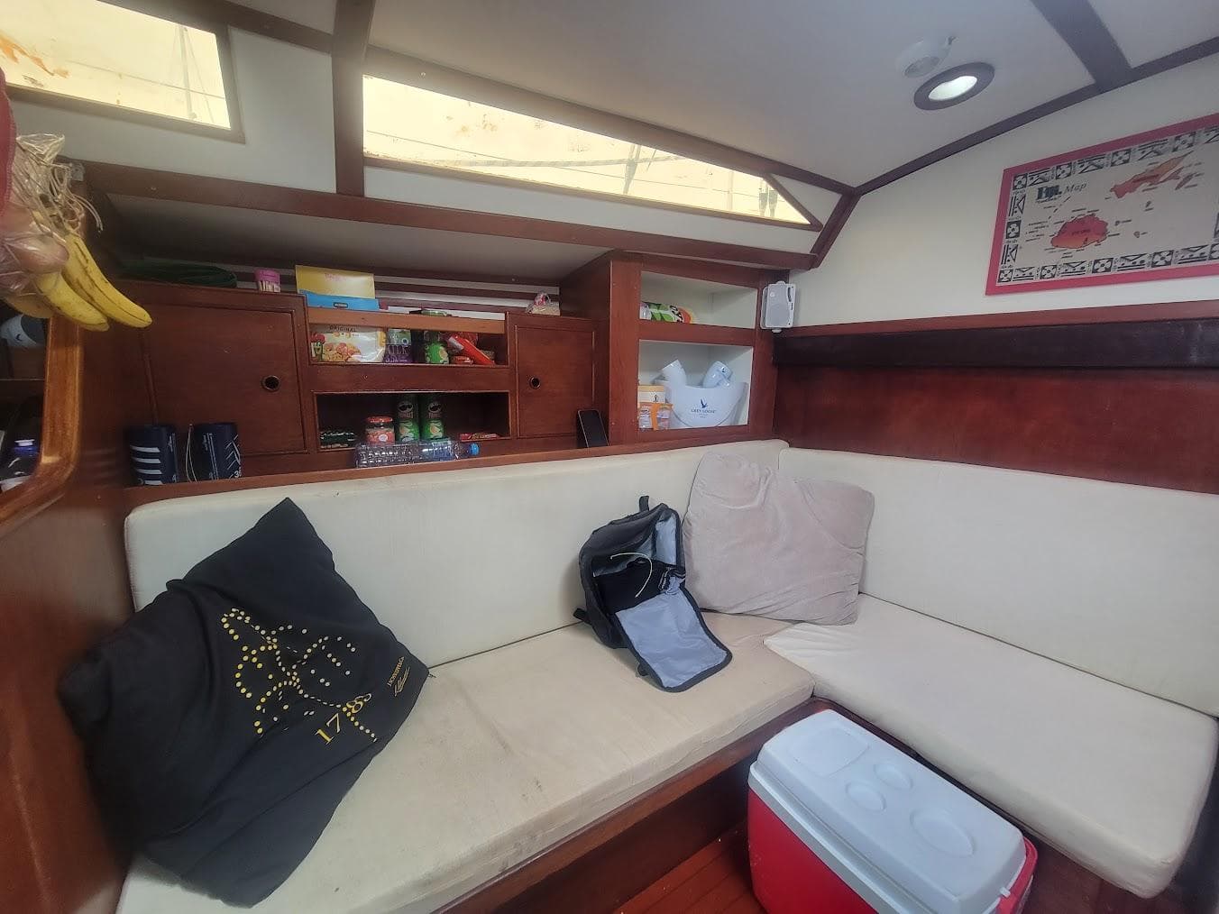 Cozy interior of 1984 Moody 419 sailboat with seating, storage, and decor.