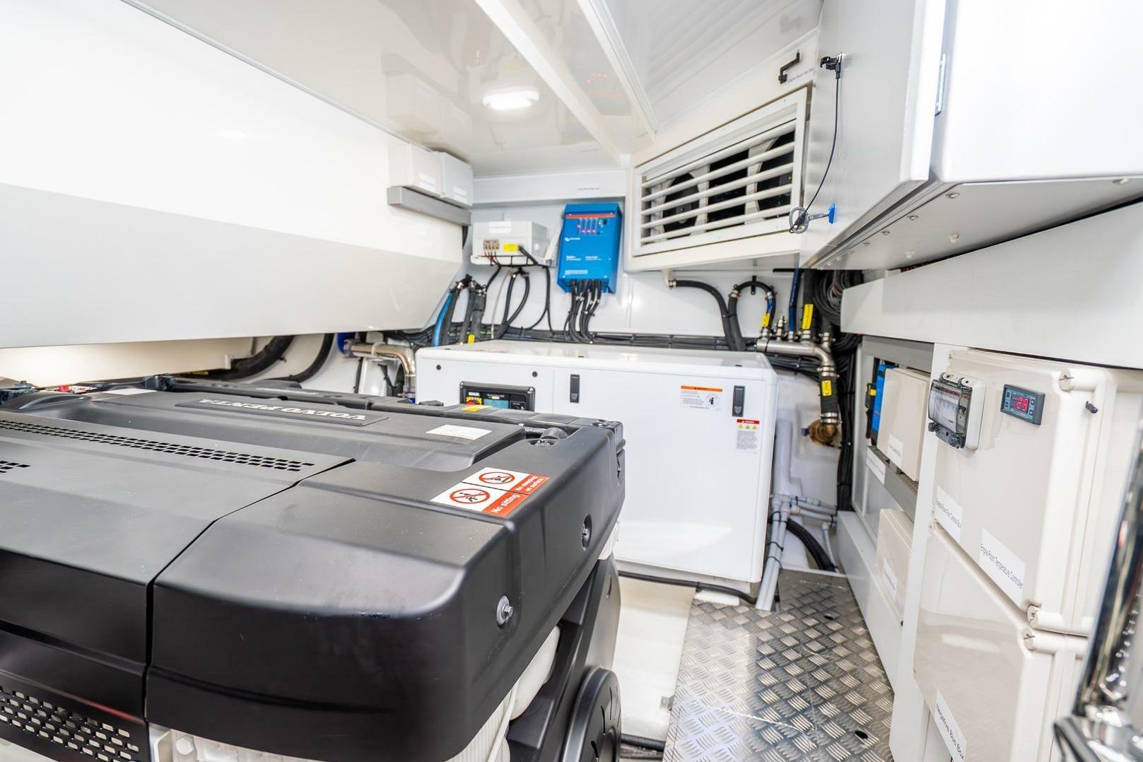 Engine room of 2025 Pearl 63 yacht with advanced equipment and control systems.