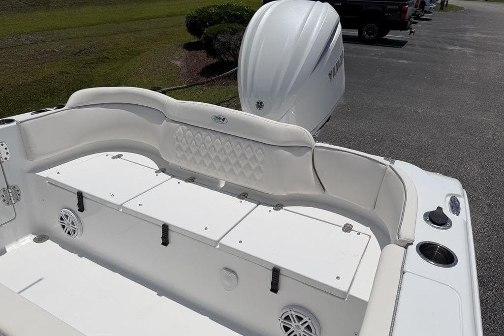 2027 Sea Hunt Ultra 239 SE boat interior with cushioned seating and storage compartments.