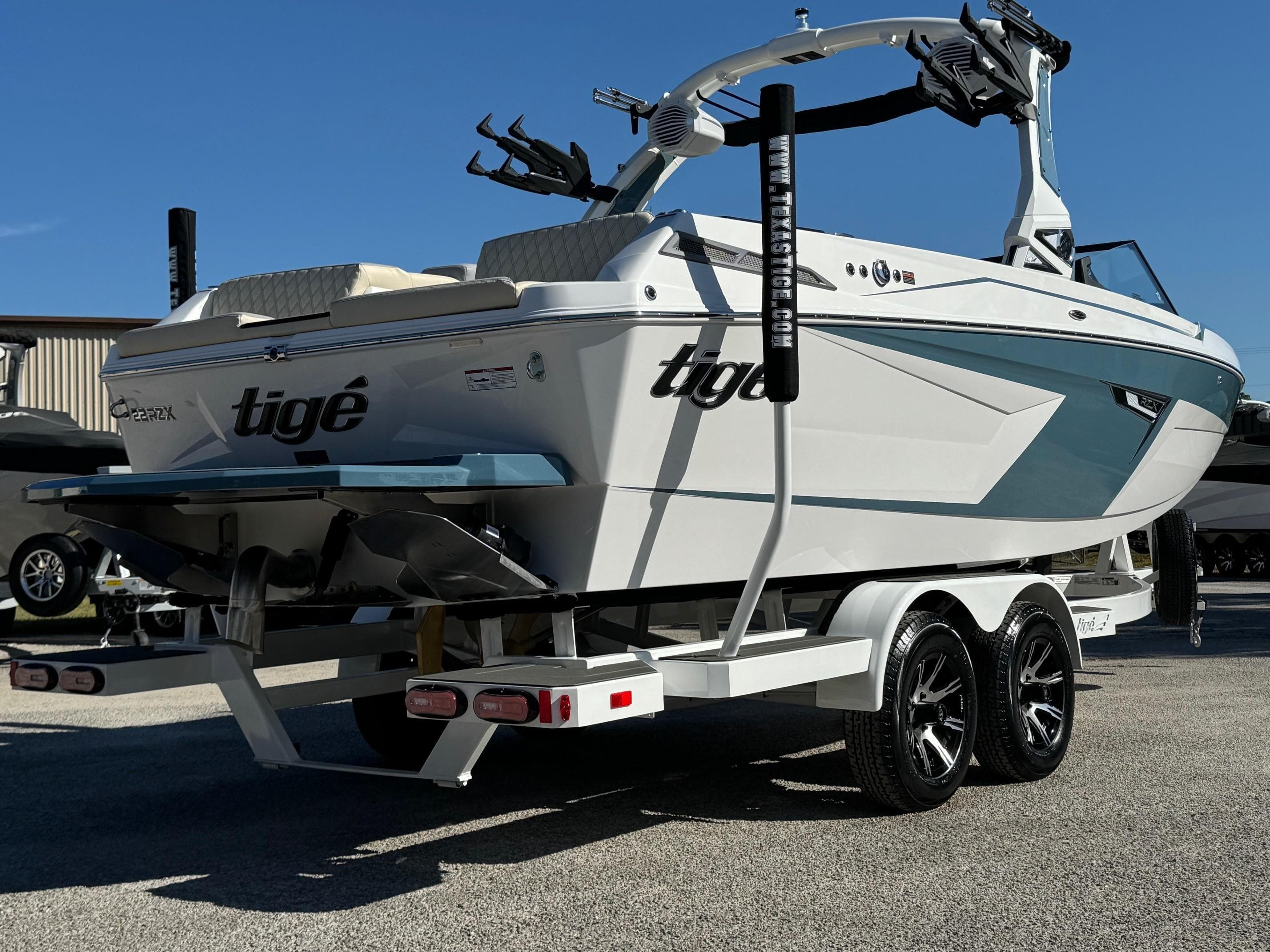 2025 Tigé 22RZX boat on trailer, sleek design, dual axle, sunny day.