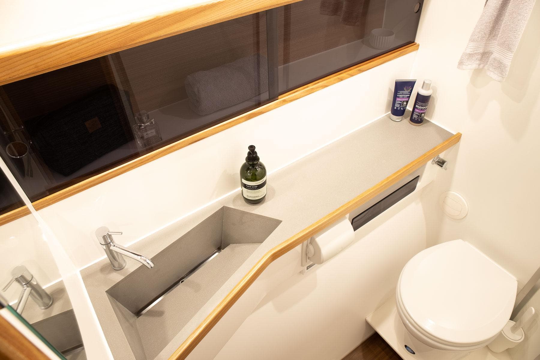 Modern bathroom in 2026 Dragonfly 40 yacht with sleek sink and toilet.
