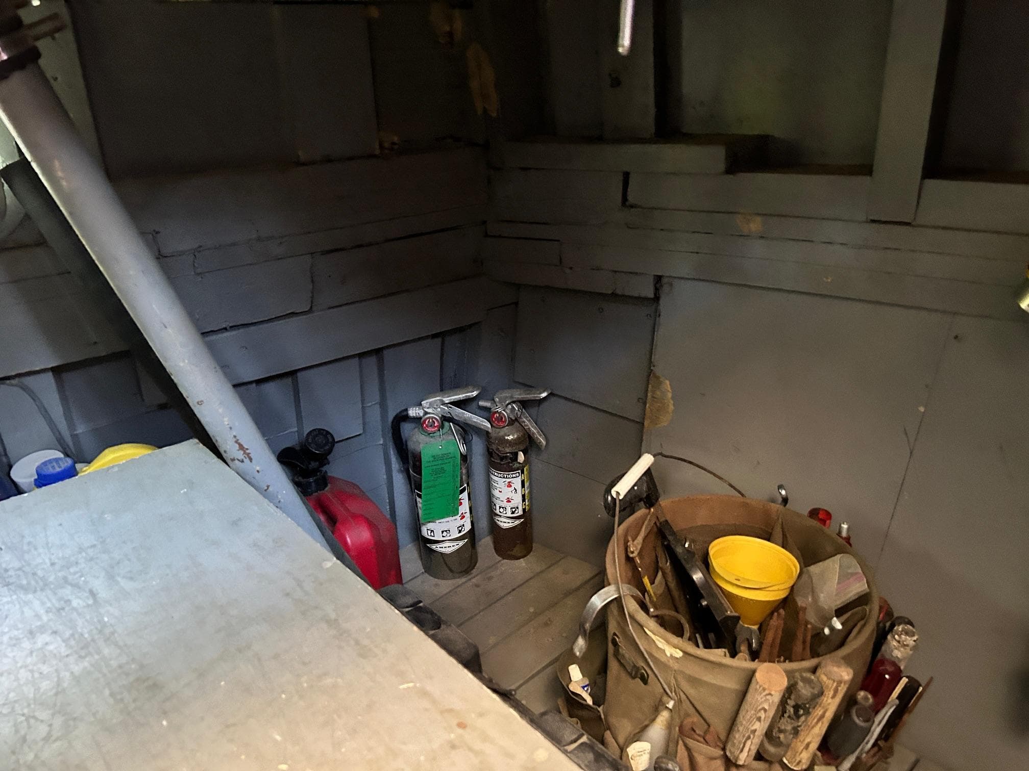 1962 Matthews 42 Double Cabin boat interior with fire extinguishers and tools.