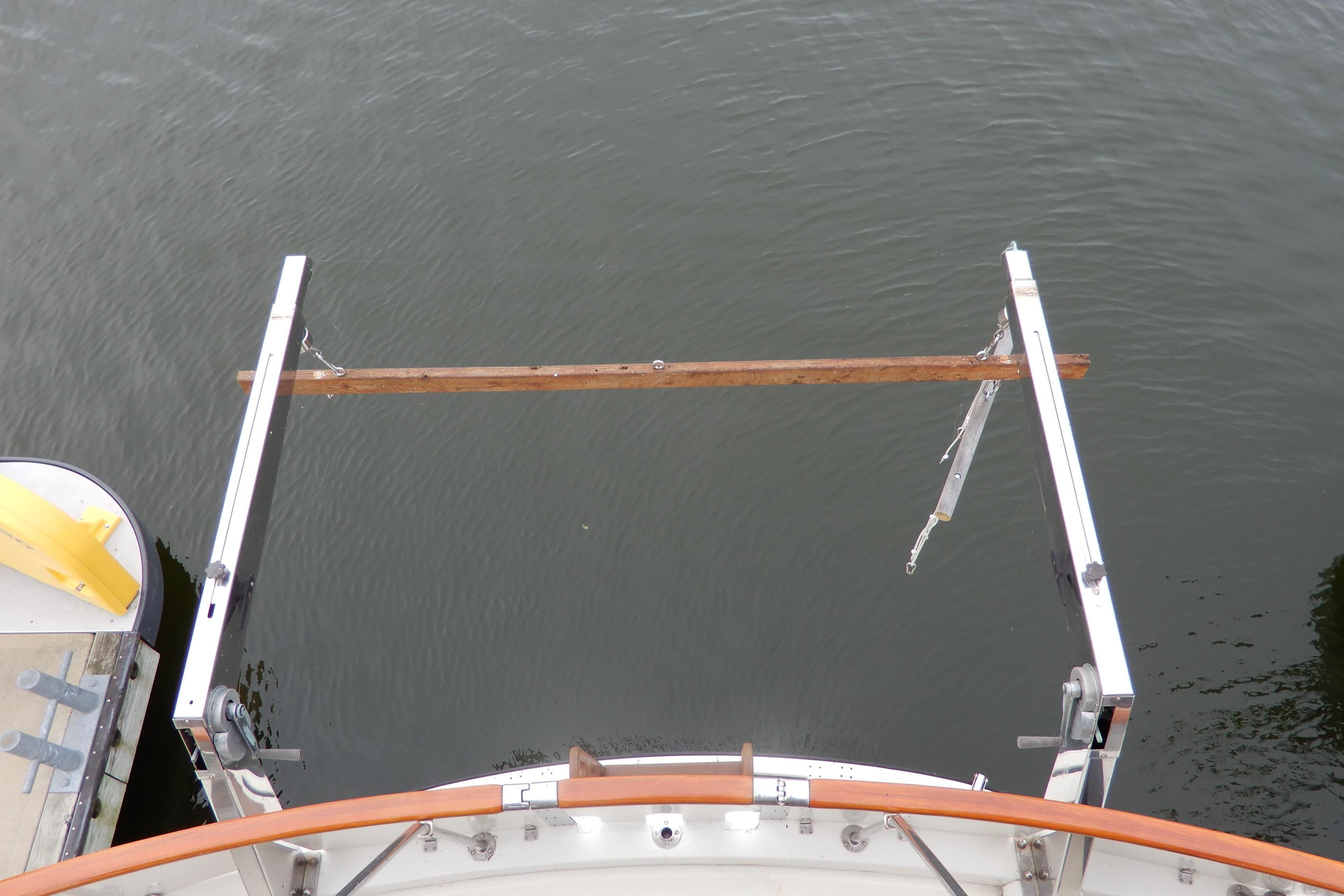 Stern view of 1979 Hatteras 53 Motor Yacht with davit system over water.