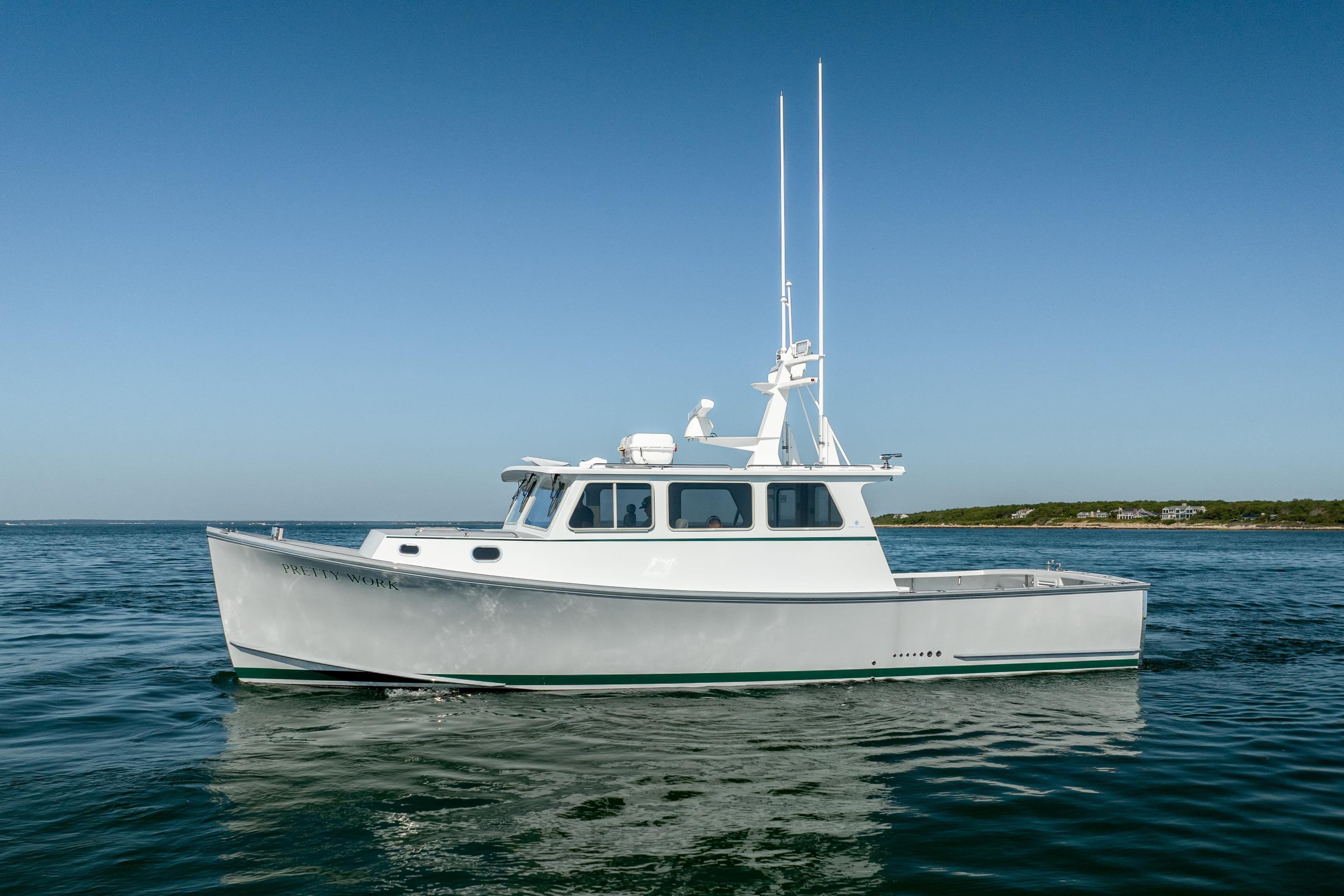 2025 Mussel Ridge 42 boat on calm ocean waters under clear blue sky.