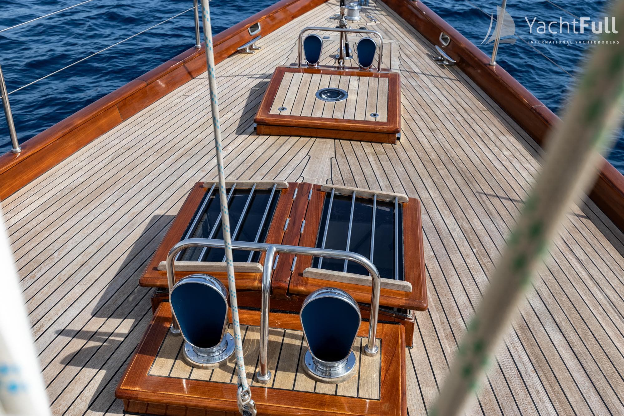 Deck of 2003 Bestevaer 65 yacht with wooden finish and ocean view.