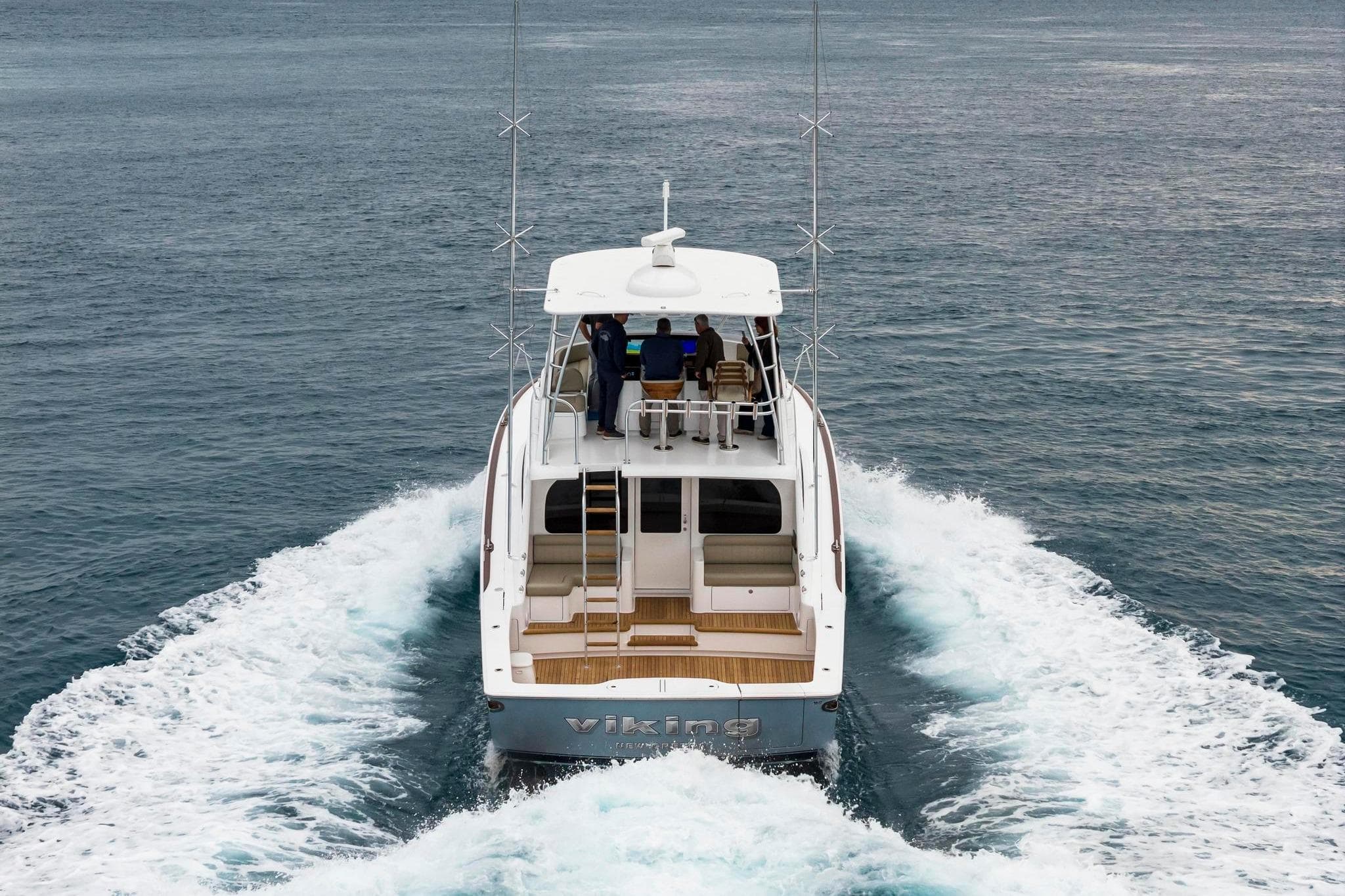 2026 Viking 50 Billfish yacht cruising on open water, rear view.