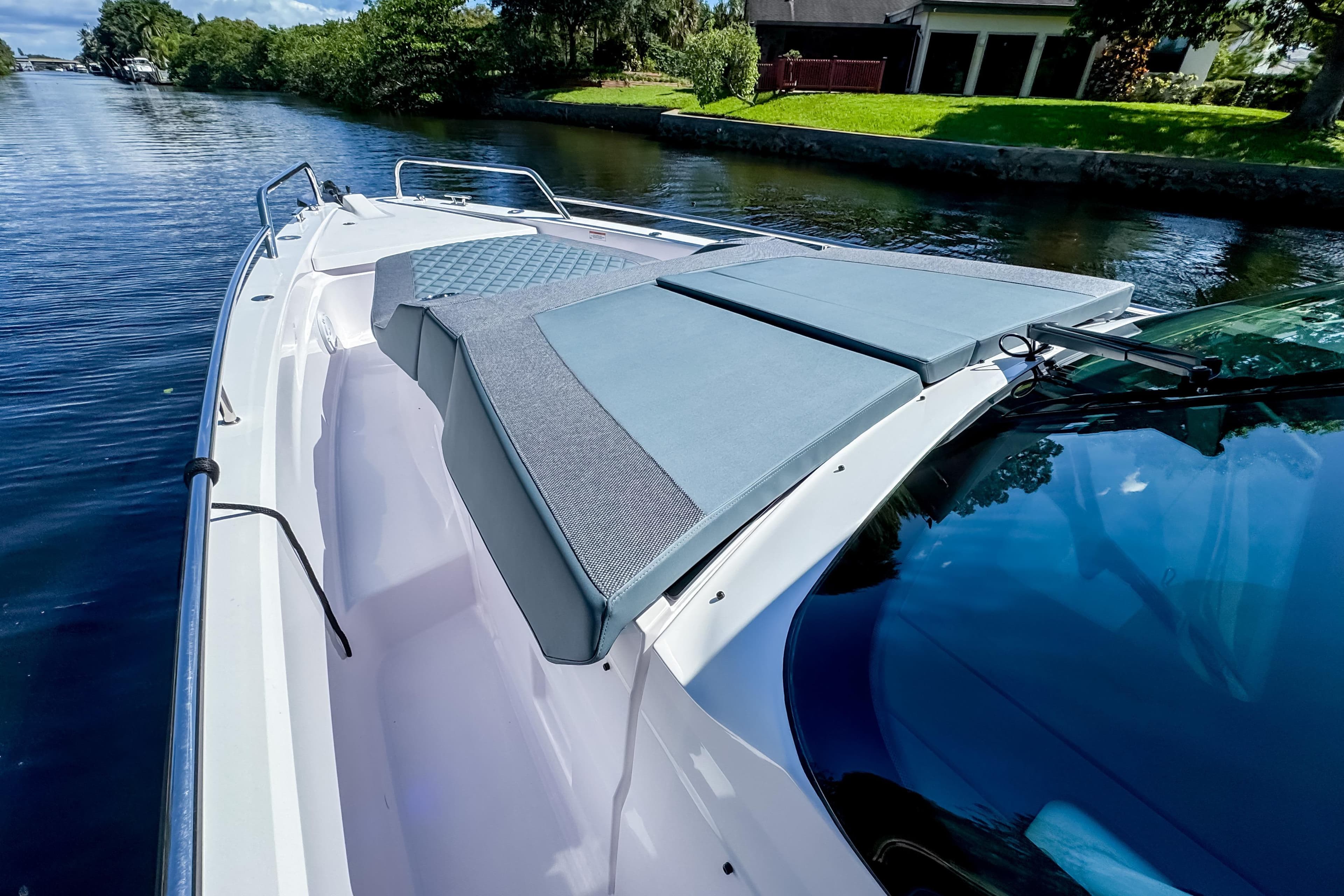 2024 Axopar 37 Sun Top boat on a serene waterway, featuring sleek design and comfortable seating.