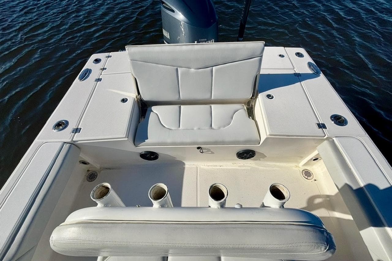 2017 Robalo 246 Cayman boat interior with white seating and rod holders.