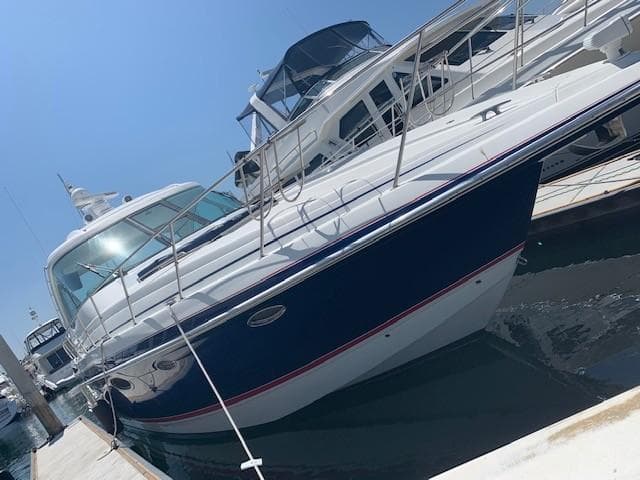 2009 Formula 45 Yacht docked at marina under clear blue sky.